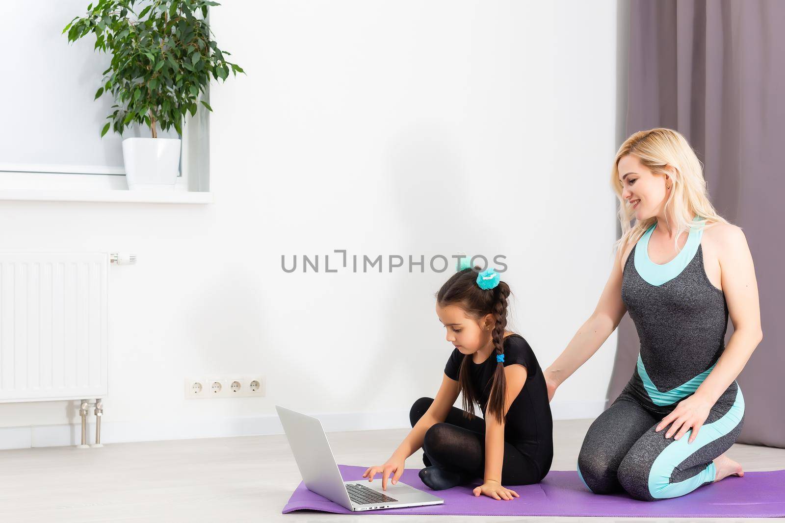 Time for yoga Attractive and healthy young woman doing exercises while resting at home