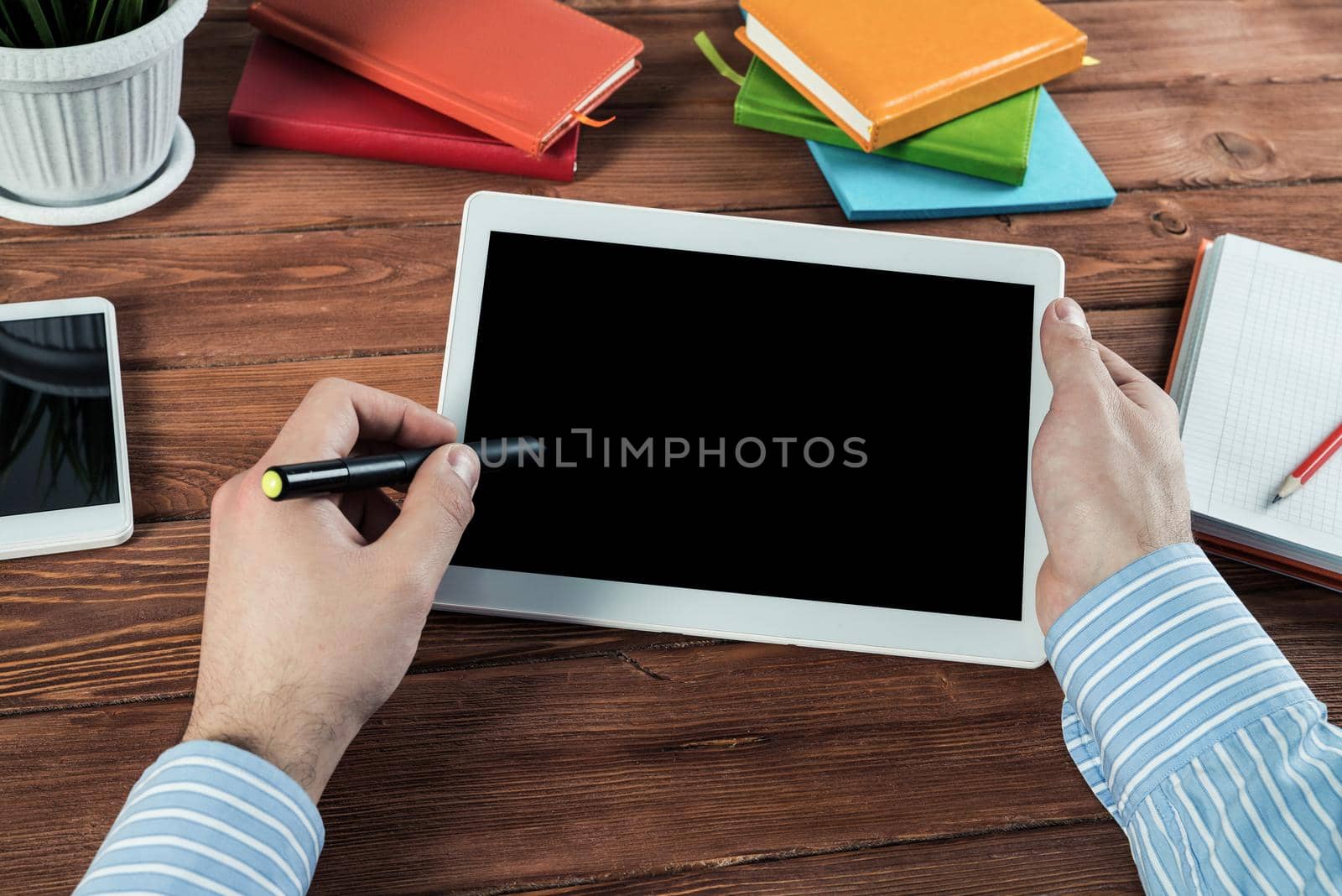 close-up of men's hands with a computer tablet. Businessman works in the office