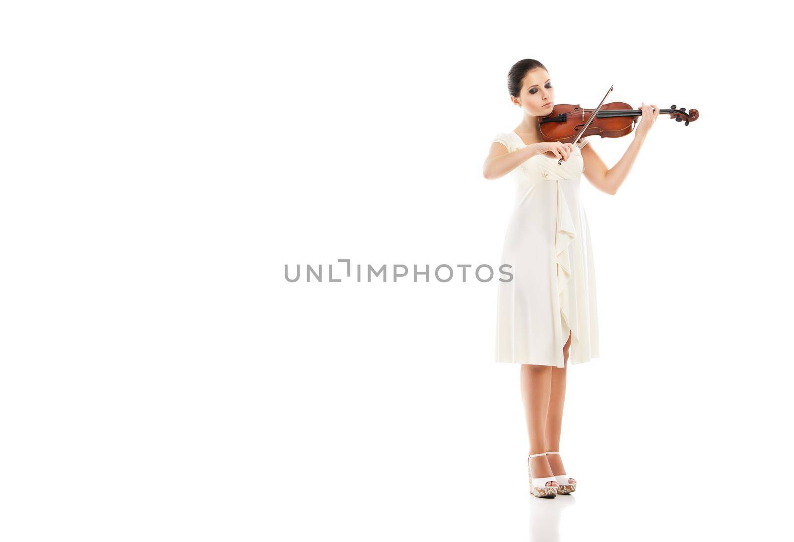 Beautiful young woman playing violin over white background