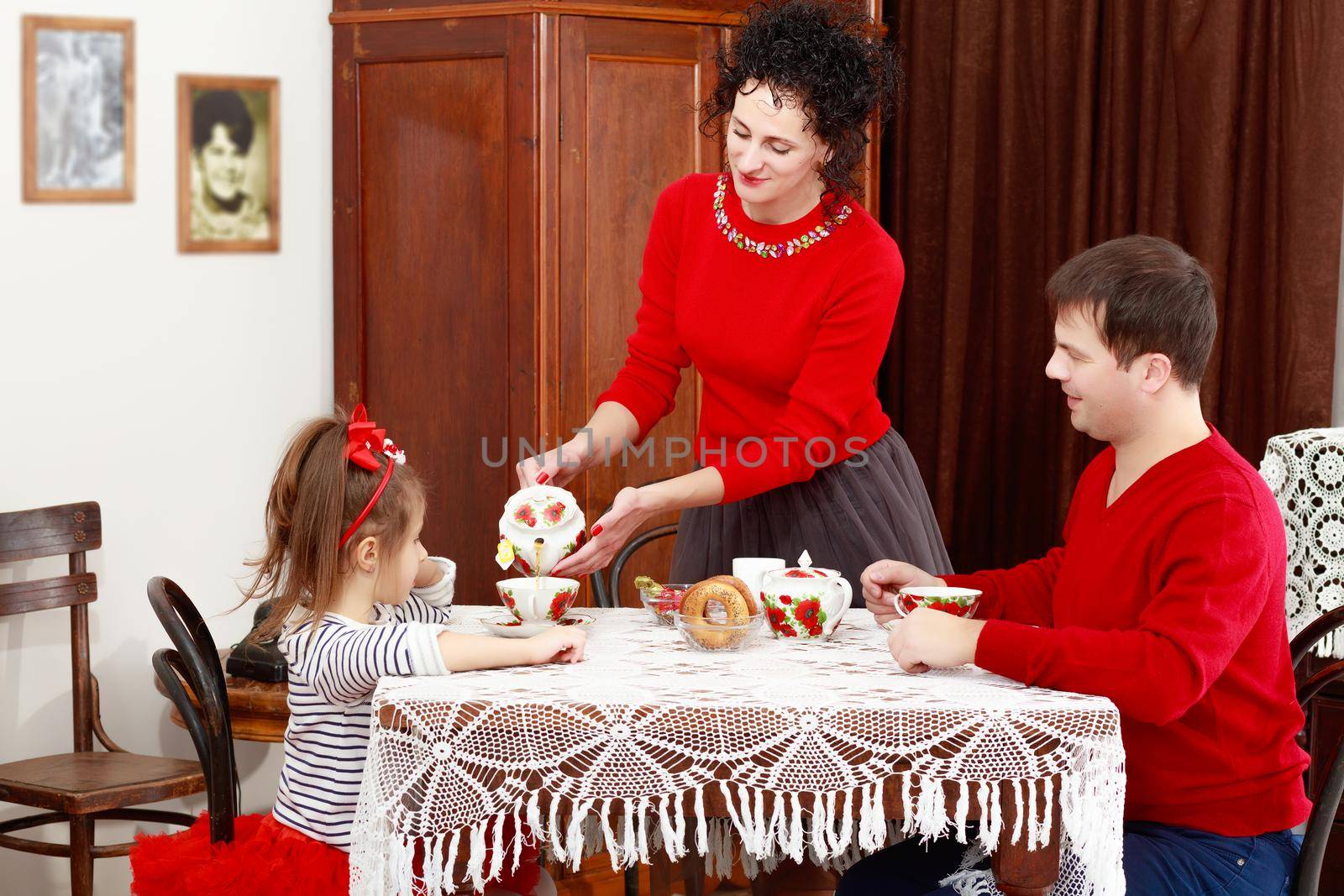 Family drinking tea in the interior of the 50 s by kolesnikov_studio