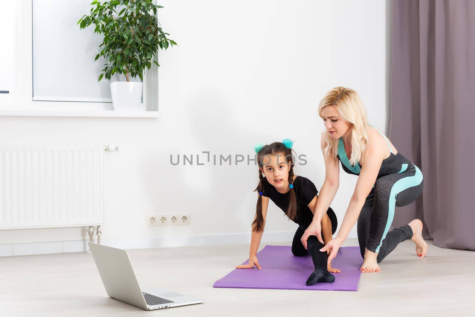 Time for yoga Attractive and healthy young woman doing exercises while resting at home