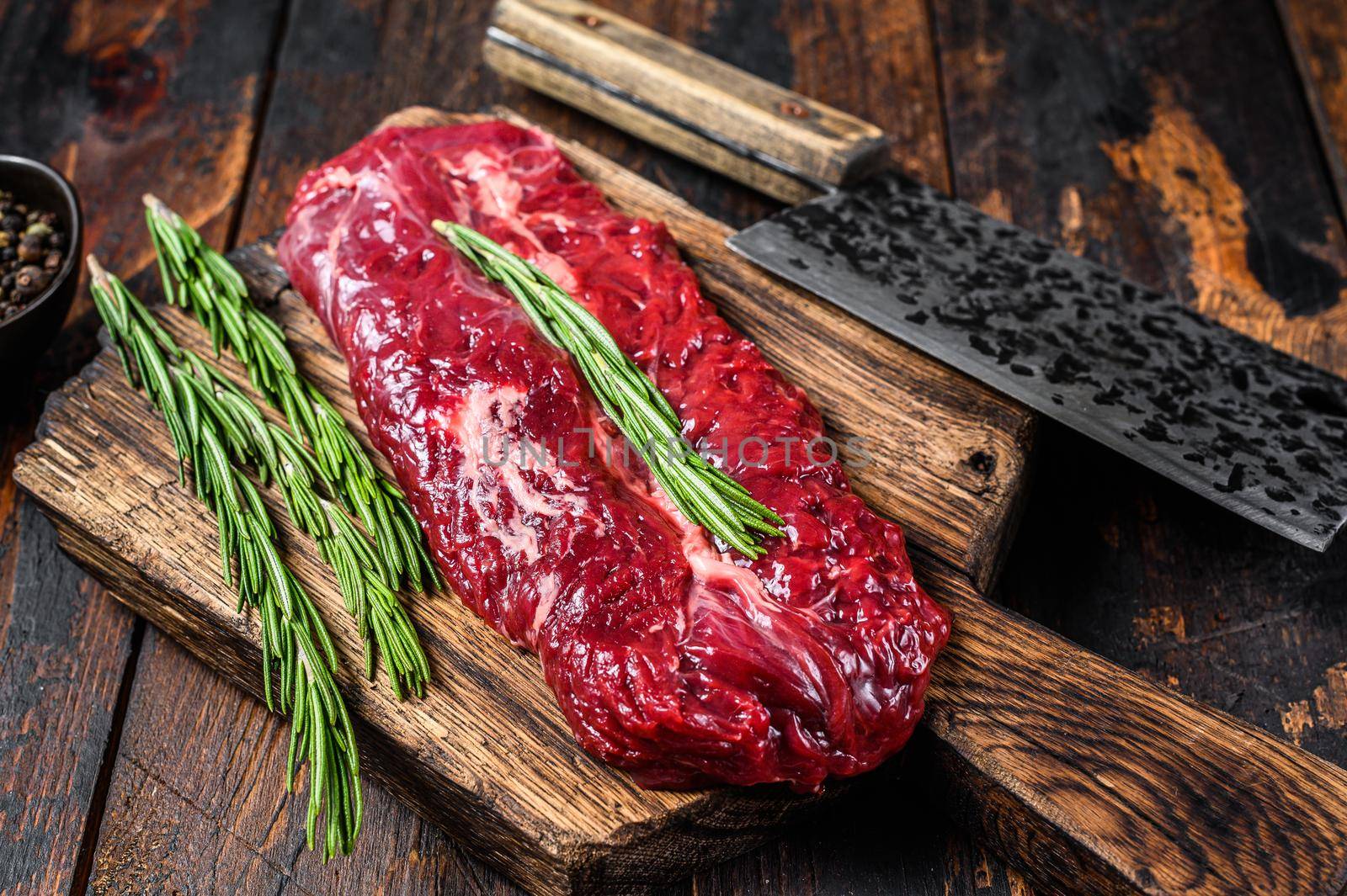 Butchers choice raw steak Onglet Hanging Tender beef meat on a cutting board. Dark wooden background. Top view by Composter