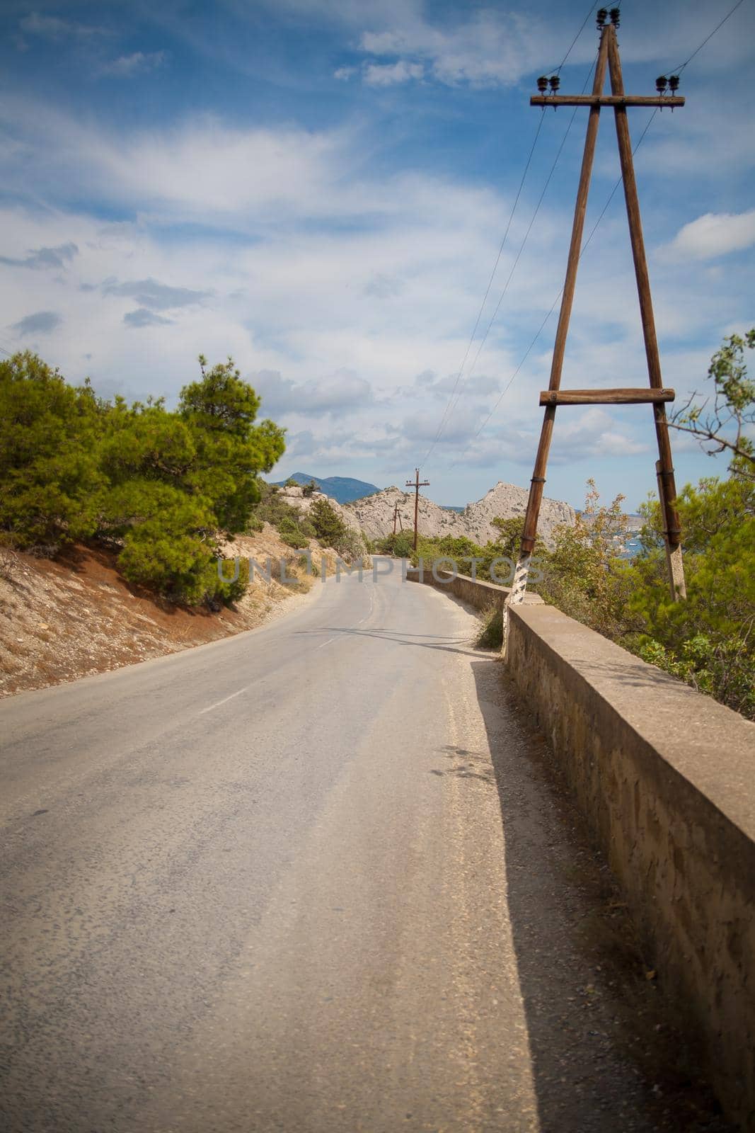 road in mountains and power line along it