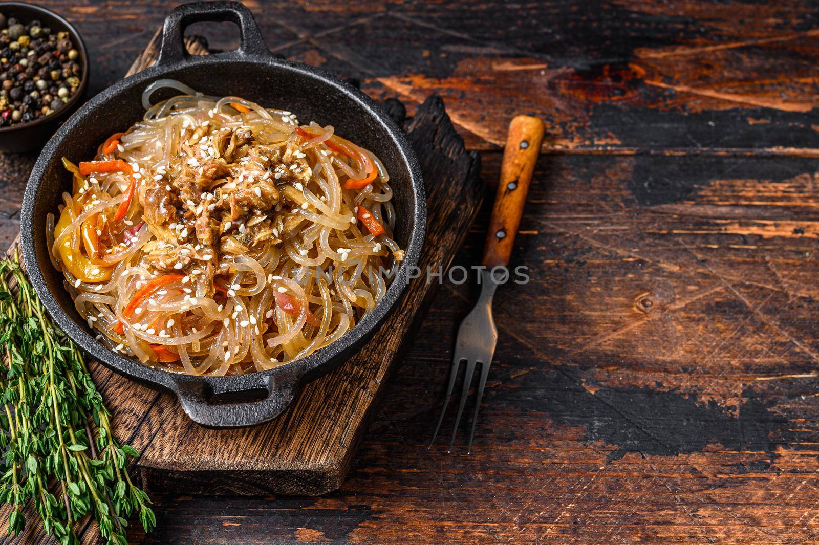 Soy glass noodles with shiitake mushrooms and chicken meat. Wooden background. Top view. Copy space.