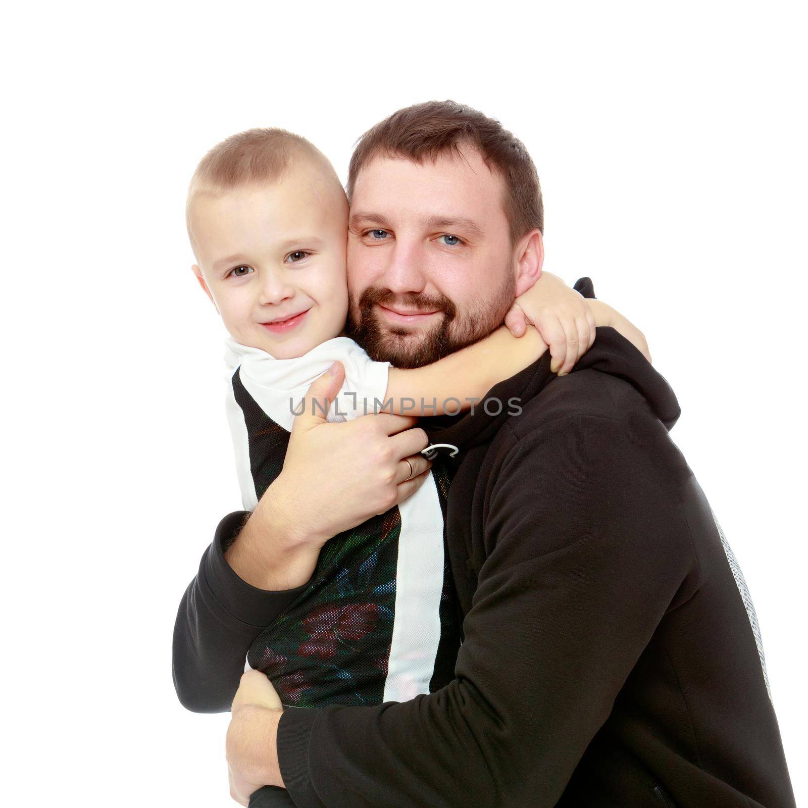 little boy who loves to play football embraces his beloved father.Isolated on white background.