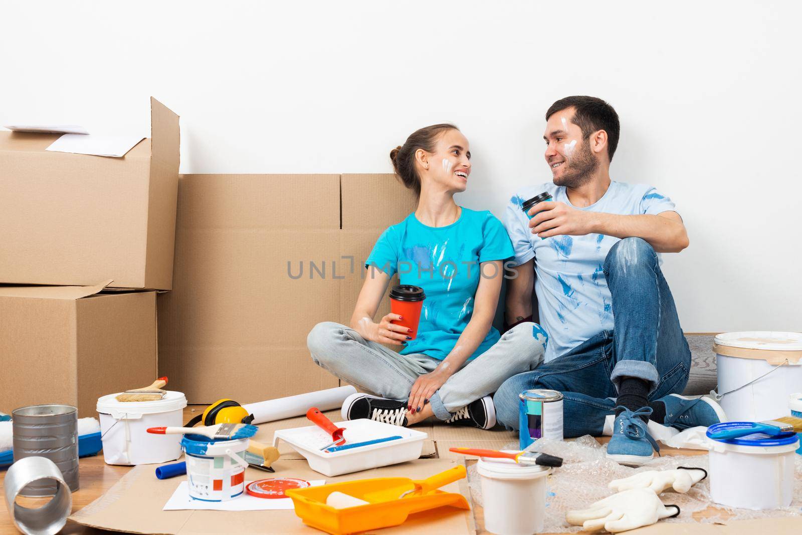 Happy smiling couple relaxing on floor by adam121