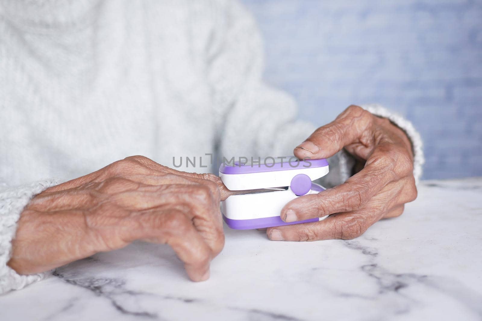 senior young women hand using pulse oximeter.