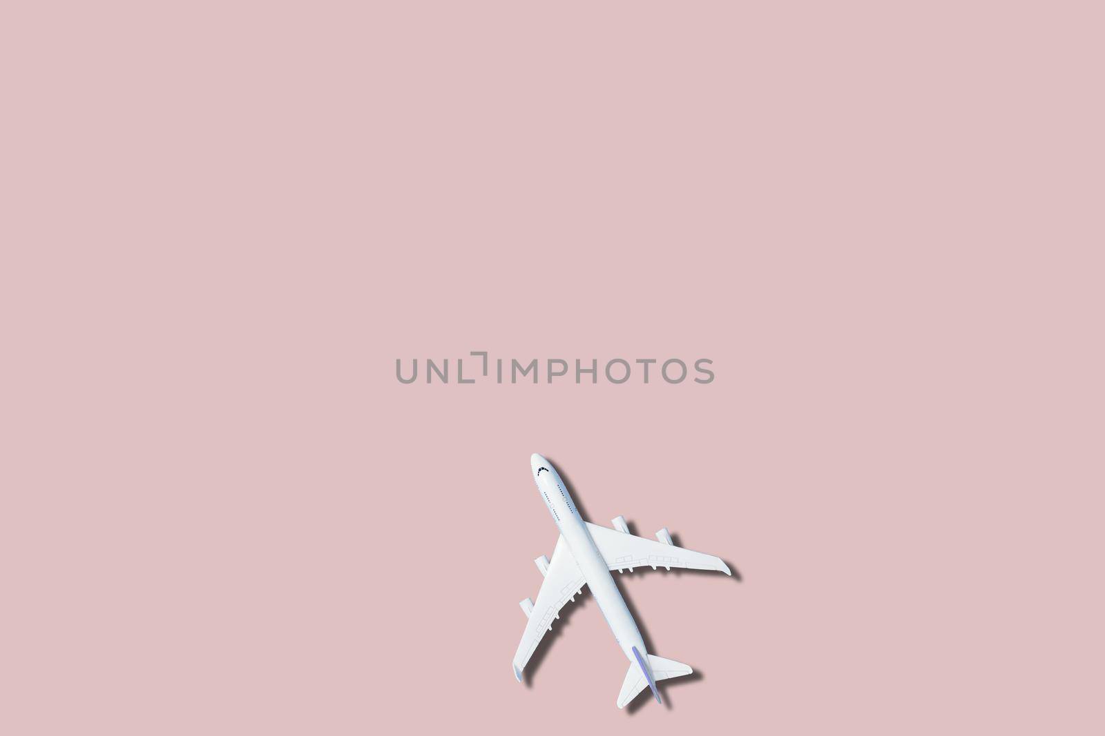 airplane figure on pink background