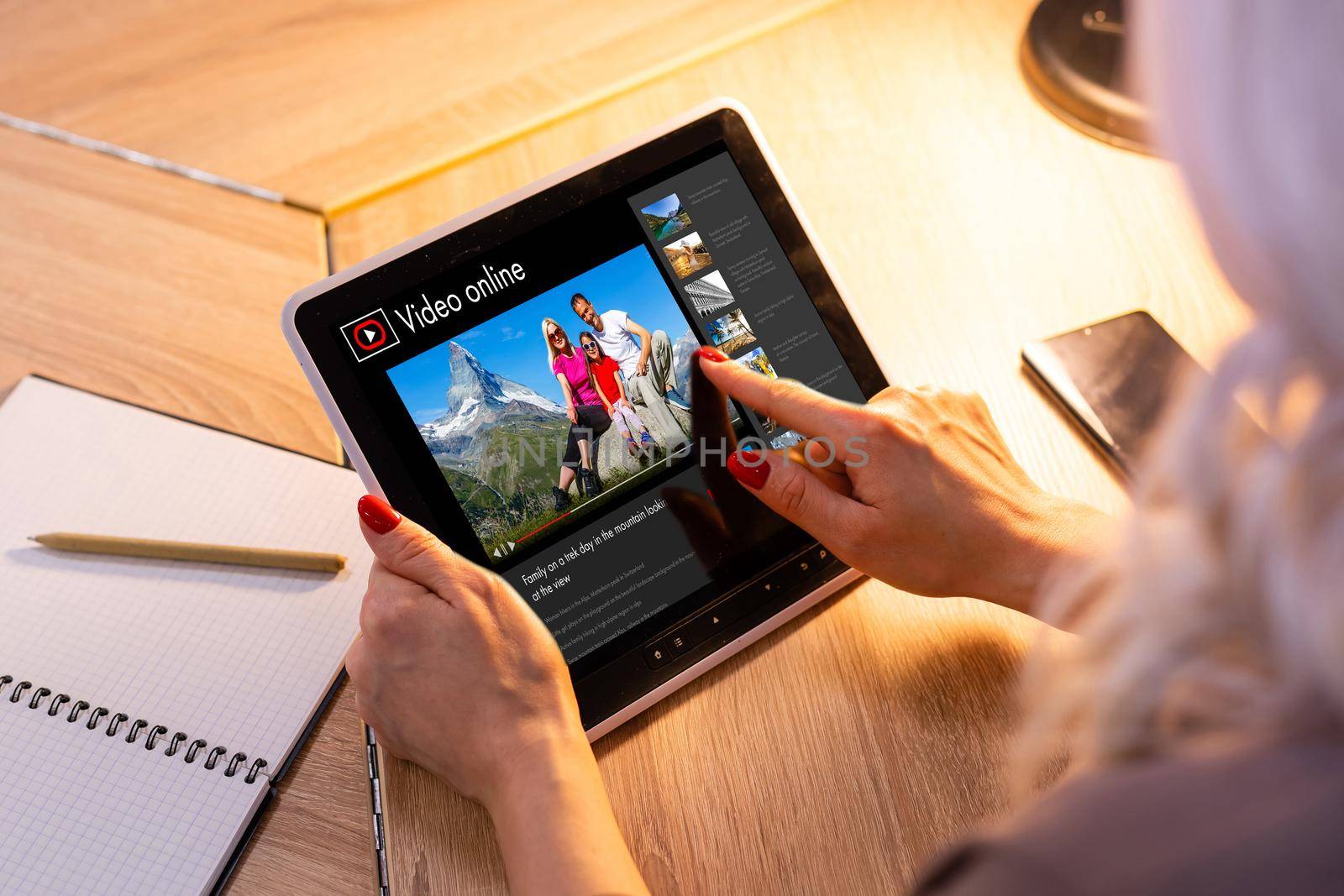 Woman watching videos online on laptop.