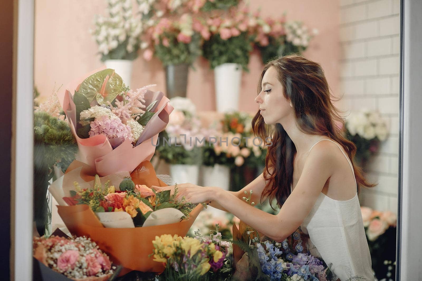 Girl with a flowers. Florist making a bouquet