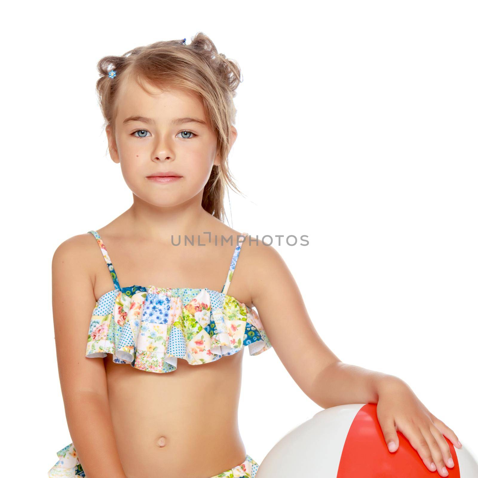 Little girl in a swimsuit with a ball by kolesnikov_studio
