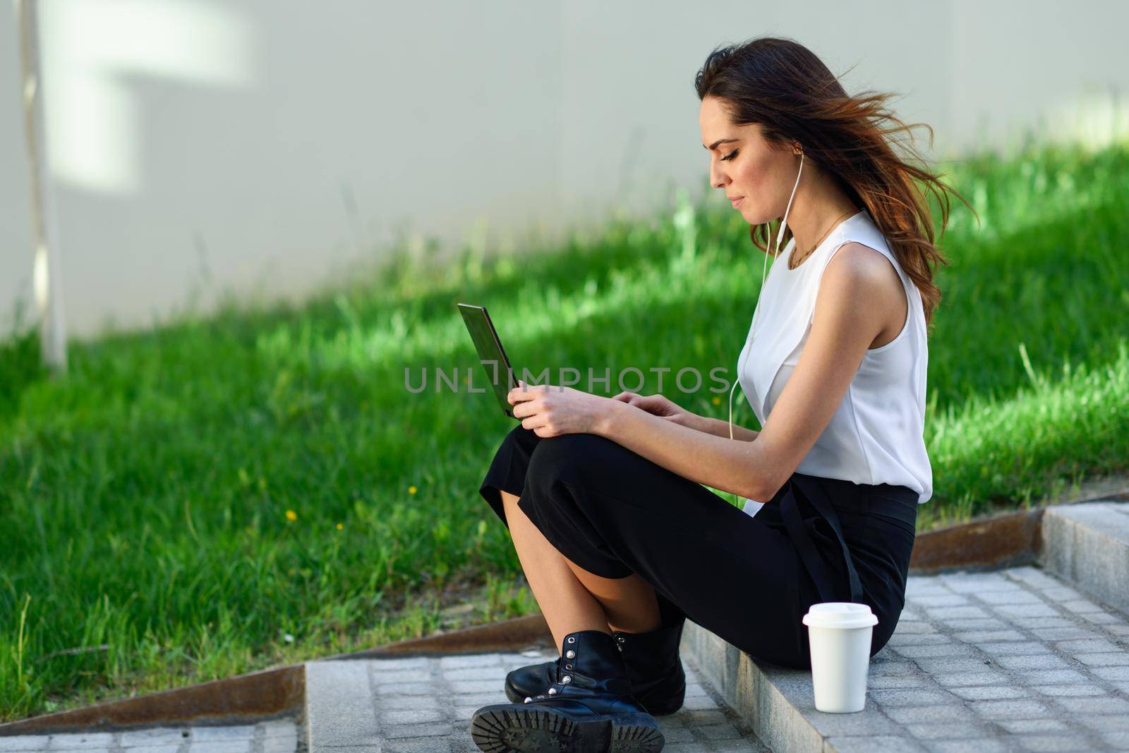 Middle-age businesswoman working with her laptop computer sitting on the floor. by javiindy