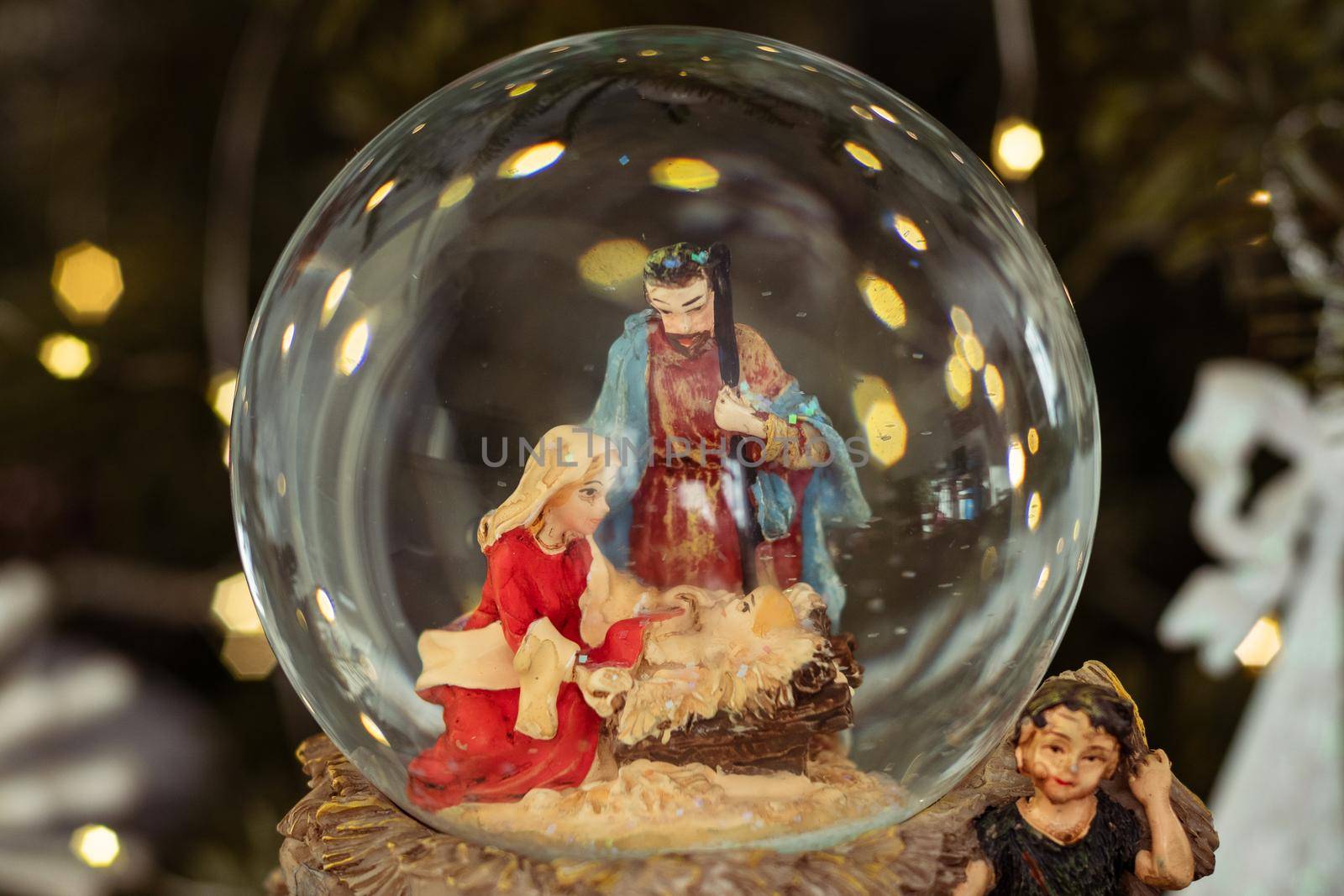 Scene of the birth of Jesus Christ in a glass ball on a Christmas tree by Godi