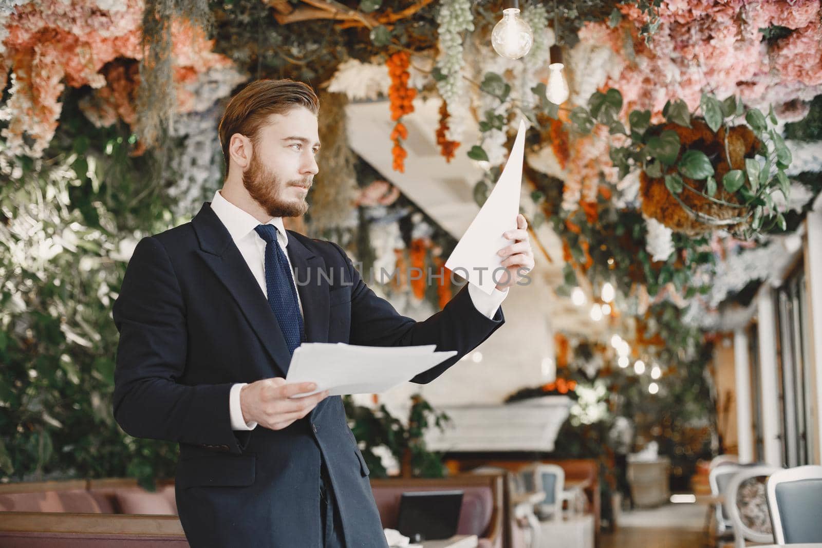 Guy in a black suit. Male at the restaurant.