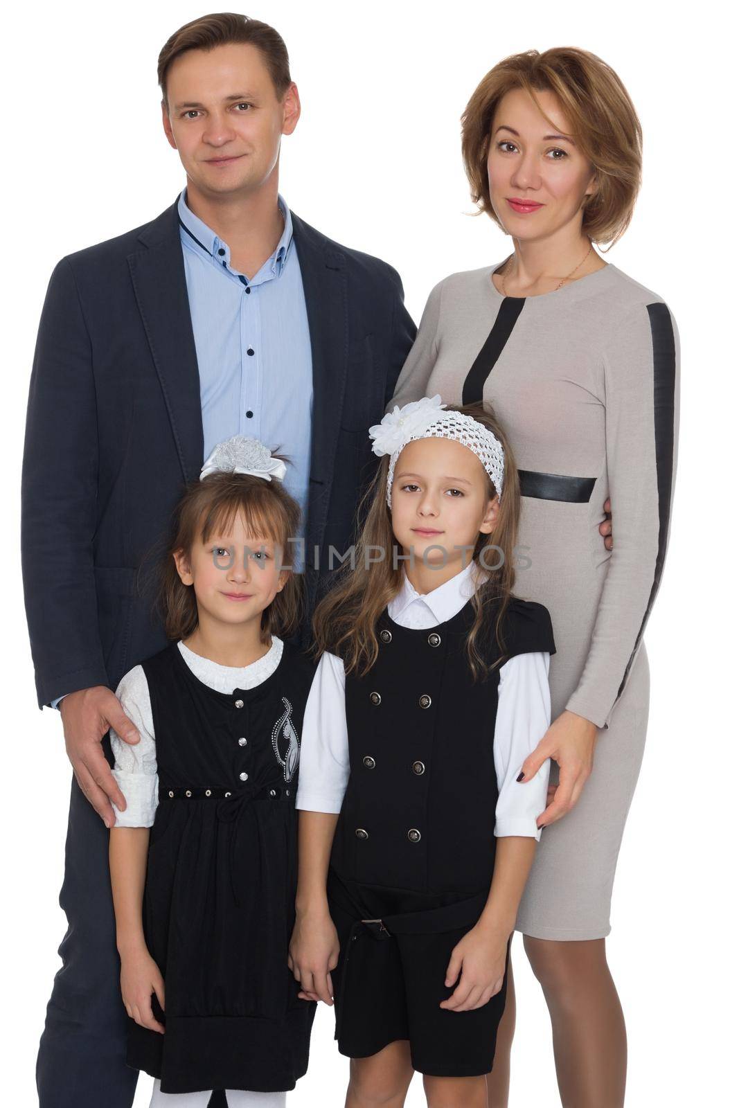 Happy Young family of 4 people . Mom, dad, and two adorable schoolgirl daughter - Isolated on white background