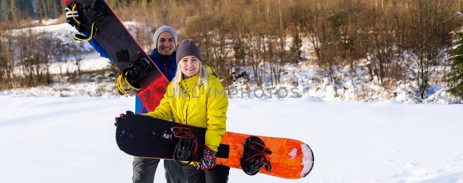 family with snowboards at winter resort by Andelov13