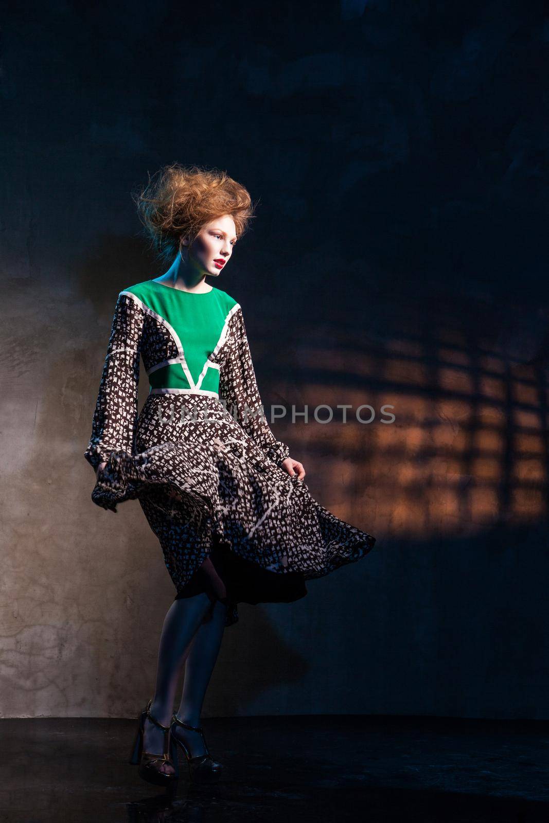 Fashion women in green dress over dark by Julenochek