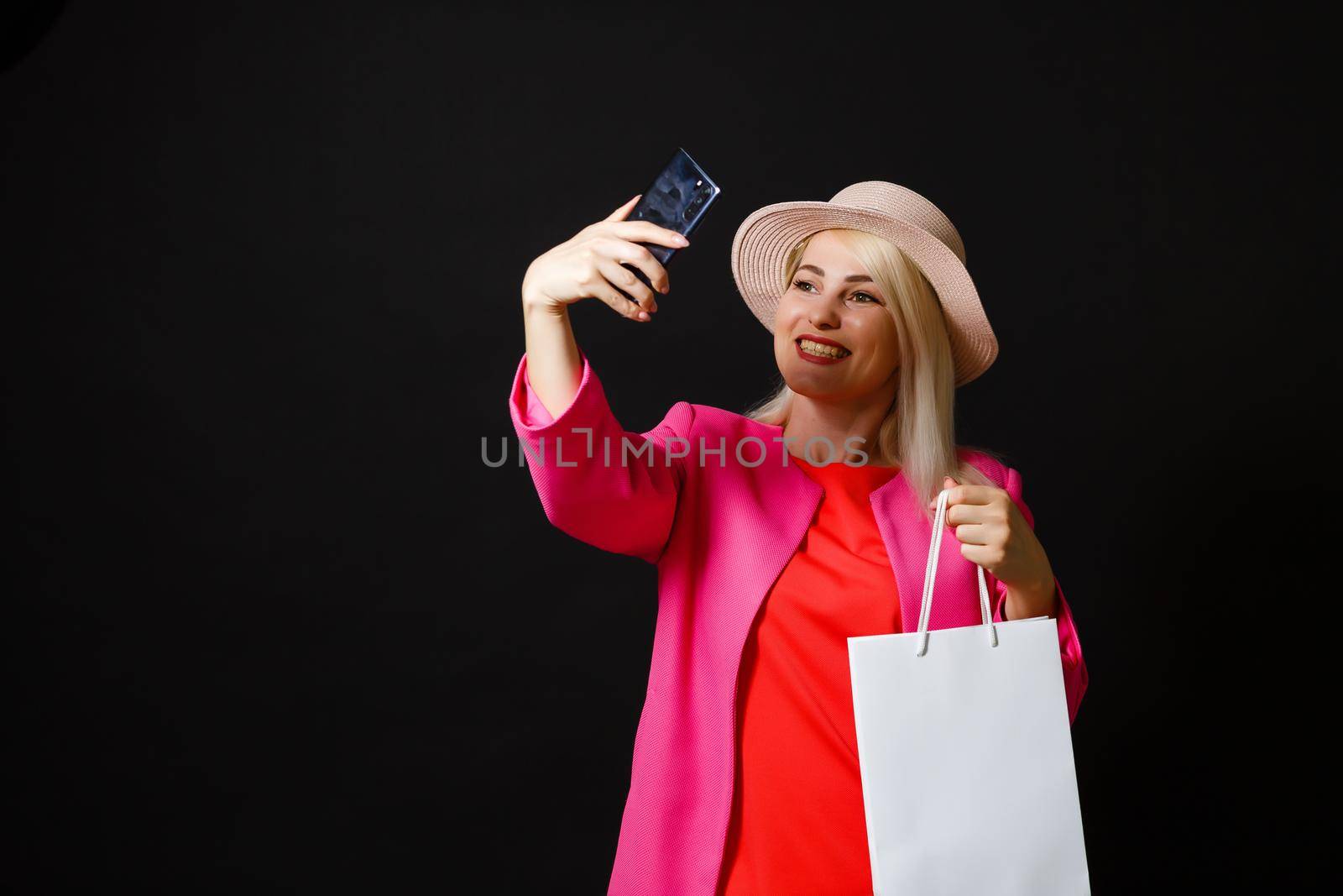 Shopping woman holding bags, isolated on black background. black friday concept