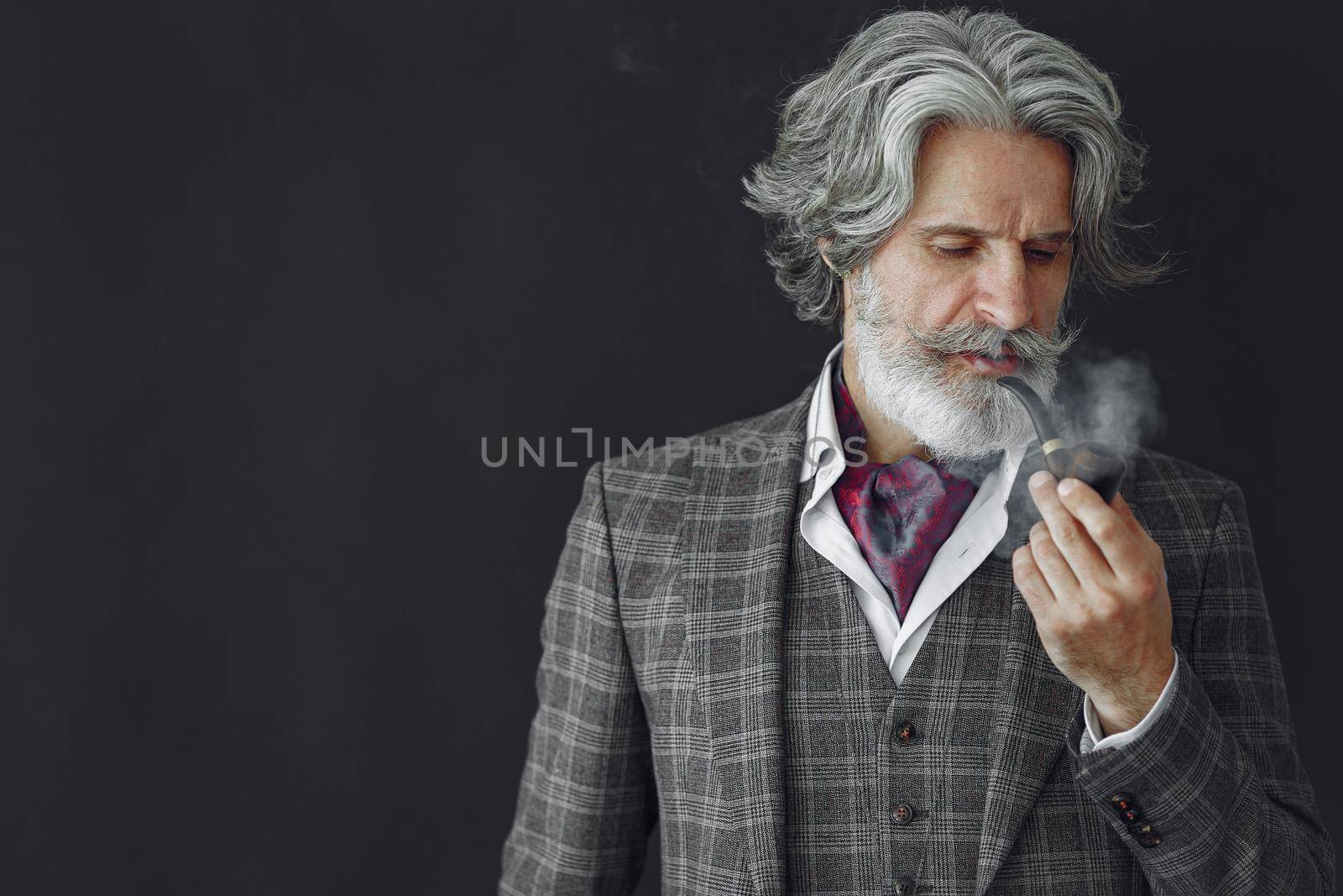 Elegant senior man with a smoking pipe by prostooleh