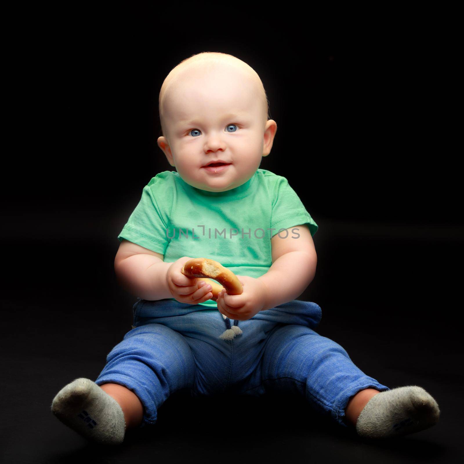 Cute little boy in studio on a black background. Concept Happy childhood, beauty and people.