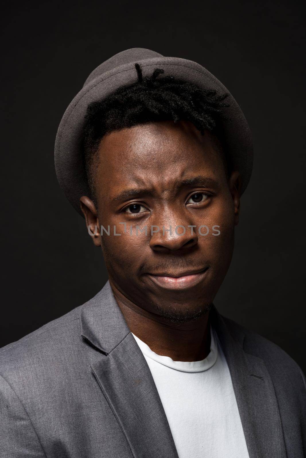 Portrait of attractive young black male studio on dark background. Studio shot