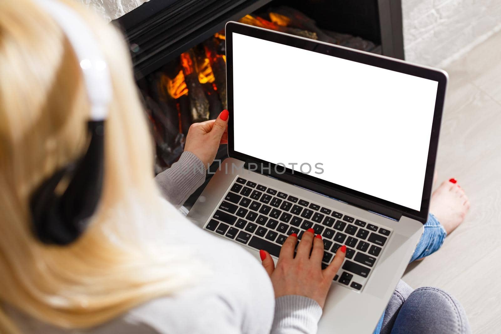 Rear view of business woman hands busy using laptop blank screen at office desk, with copyspace