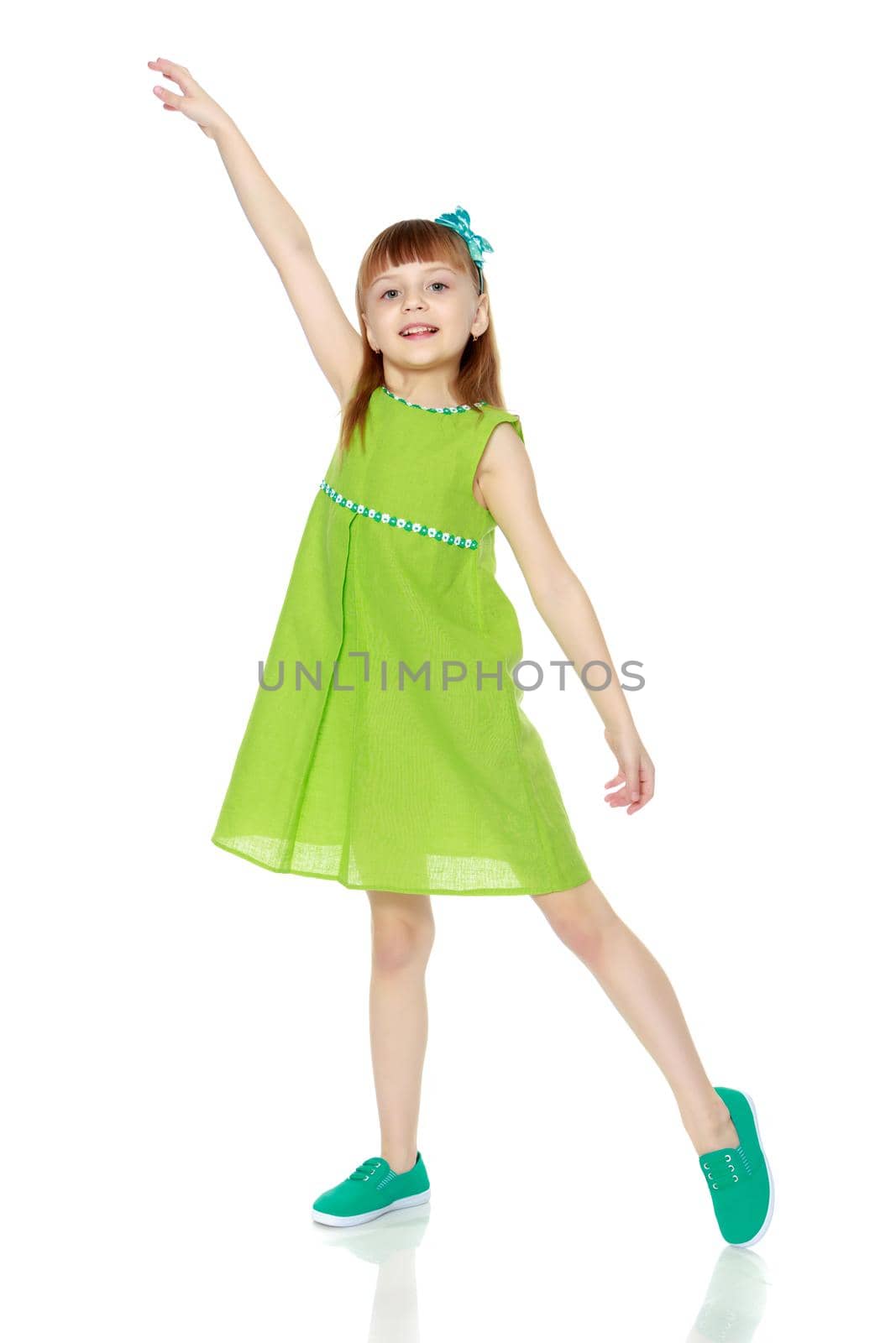 A little girl in a summer green dress. by kolesnikov_studio