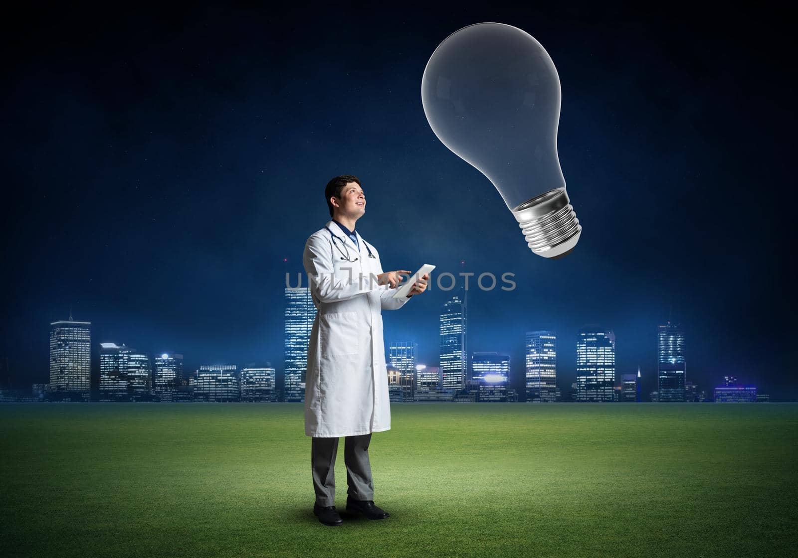 The doctor stands in front of the light bulb symbol. innovation in medicine
