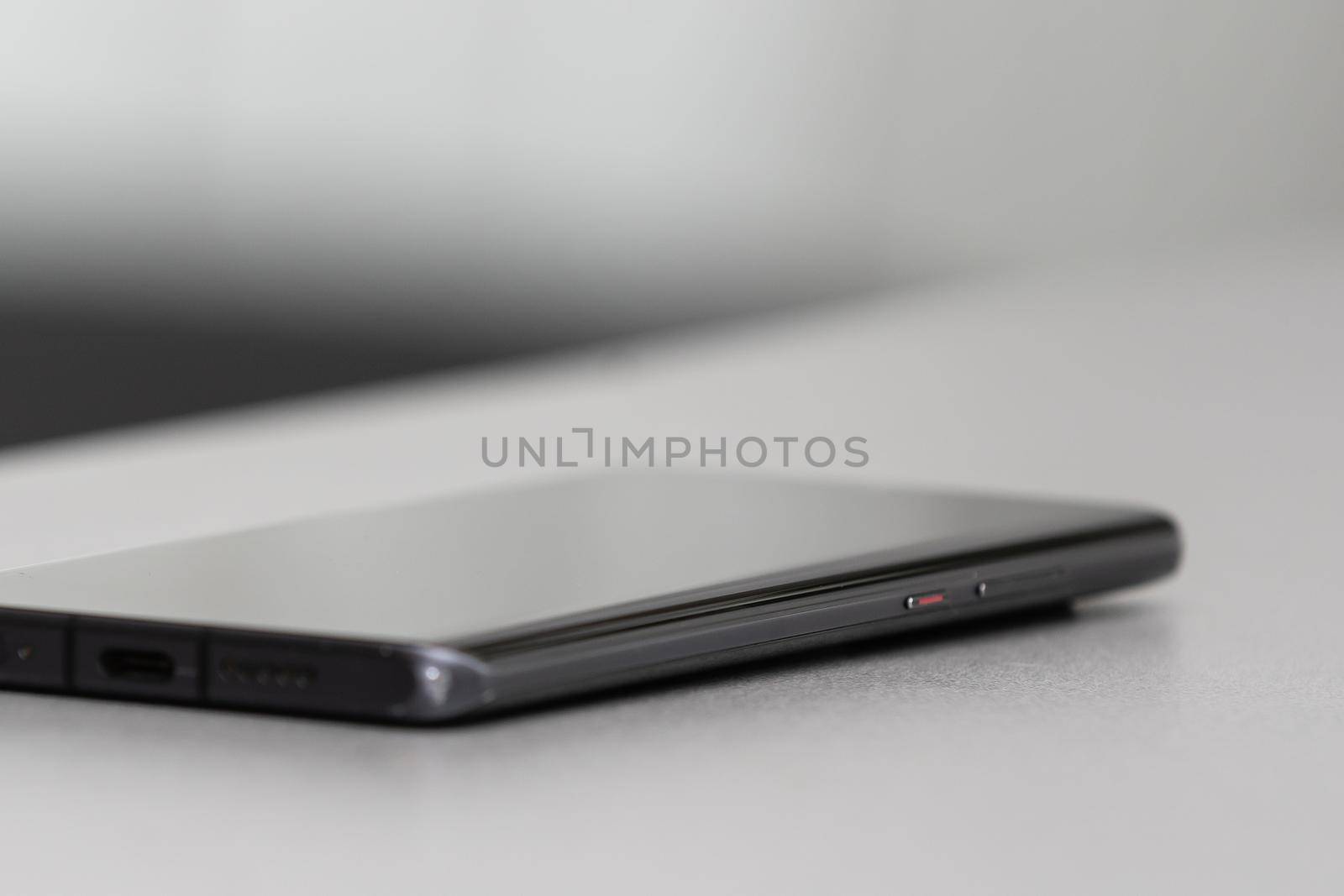 A single mobile phone on gray table