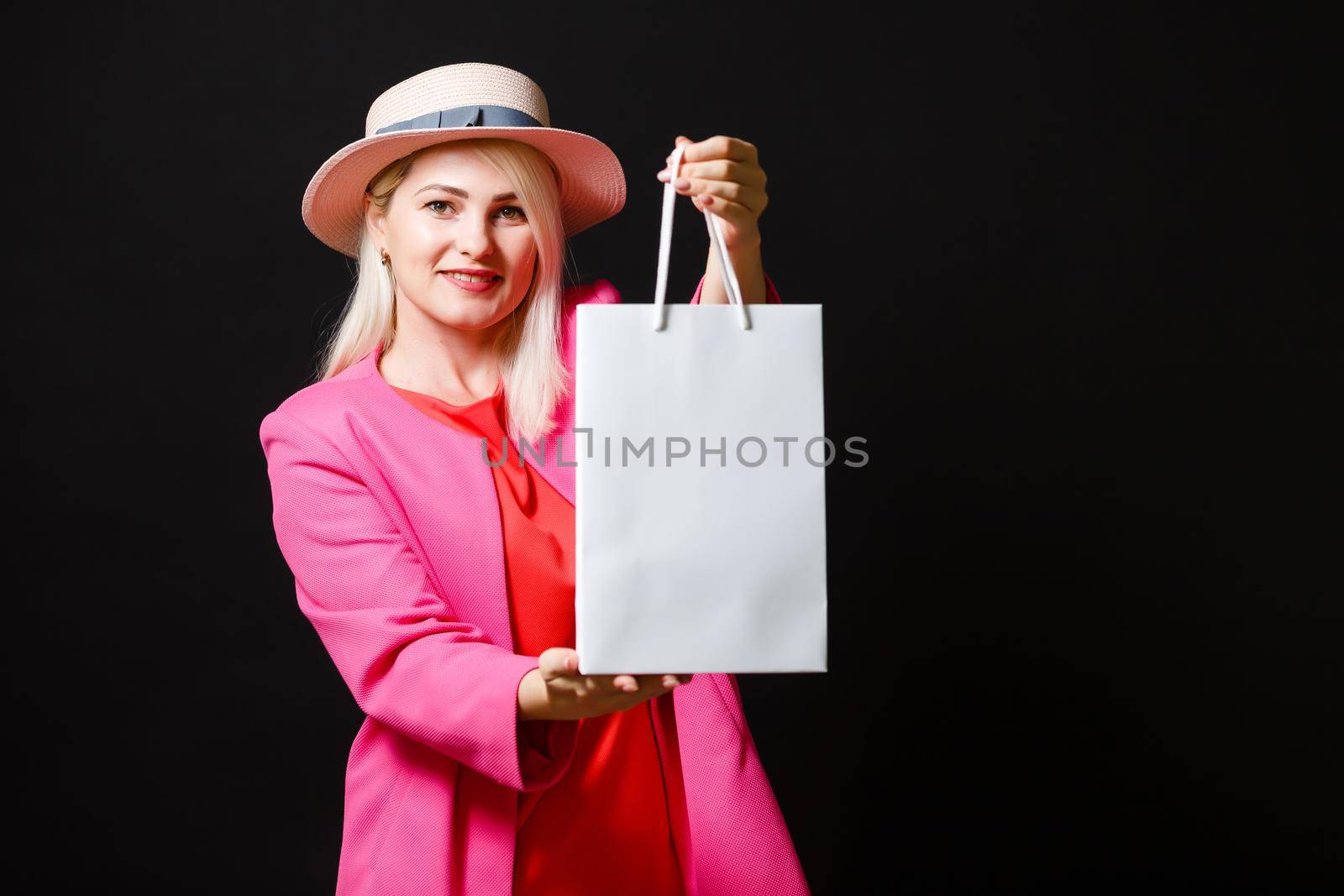 Shopping woman holding bags, isolated on black background. black friday concept by Andelov13