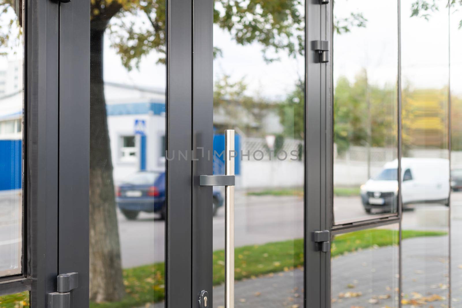 Outside solid glass door with building exterior.