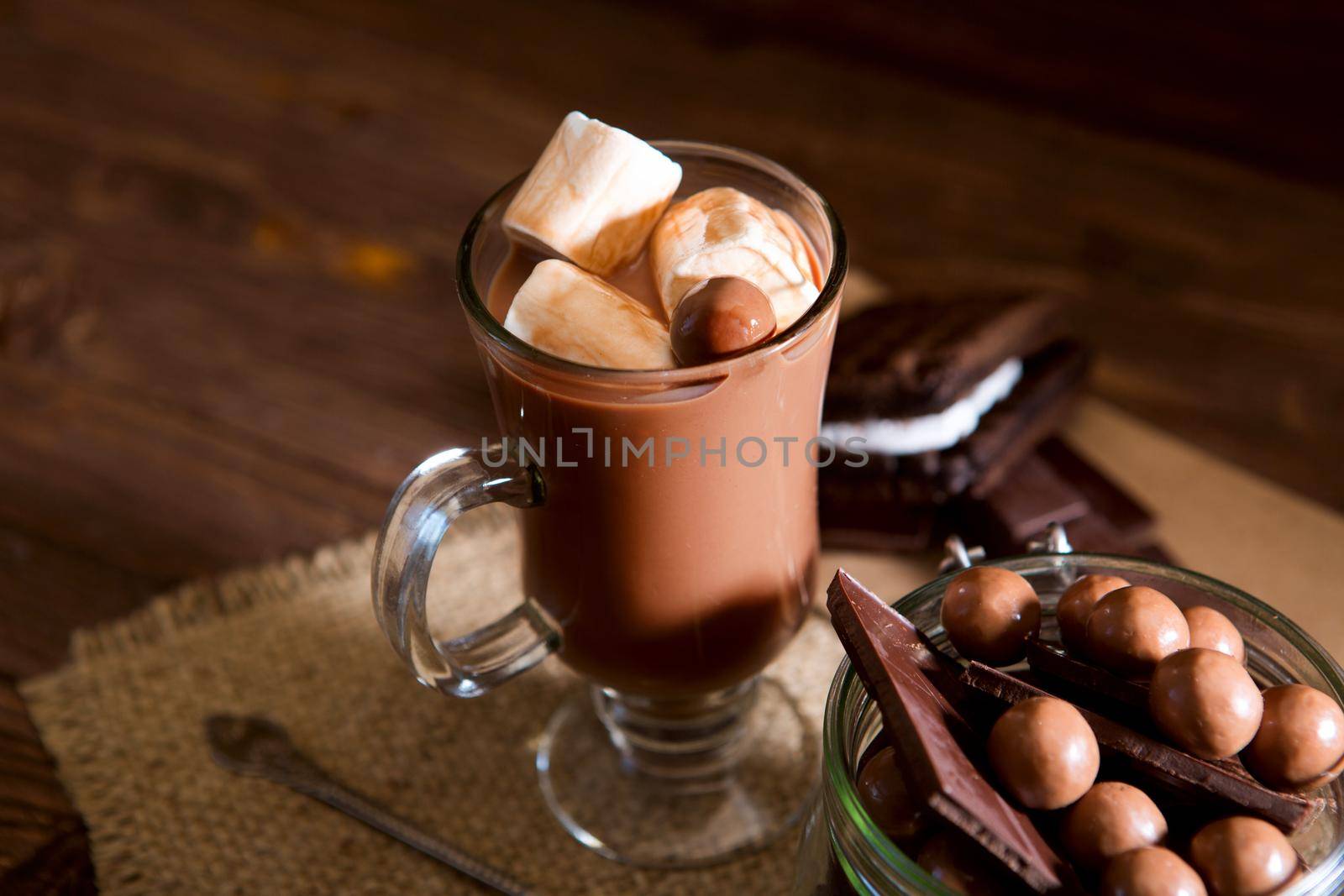 Homemade brown sweet chocolate cocktail on wooden table.