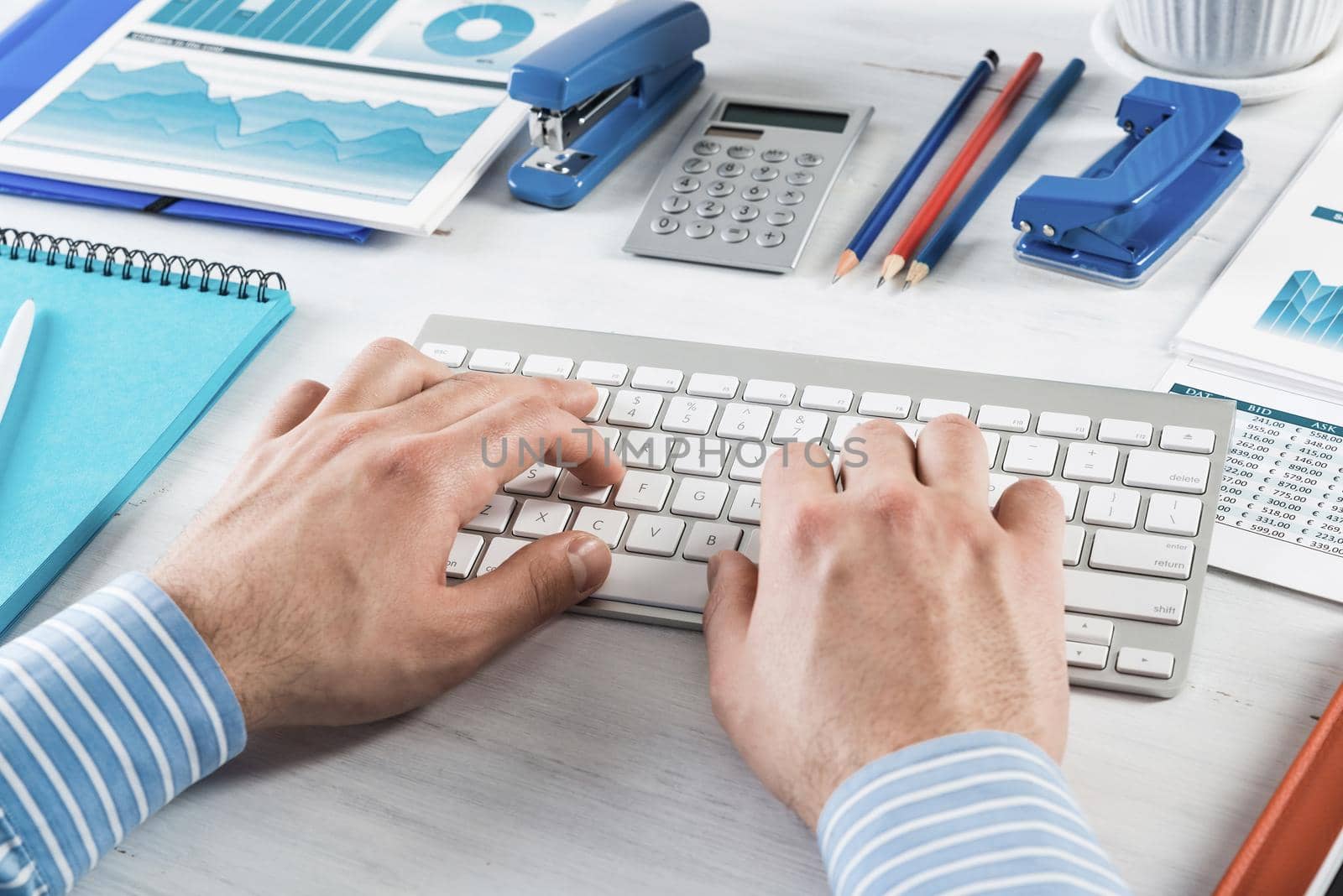 close-up men's hands type on the keyboard. office work