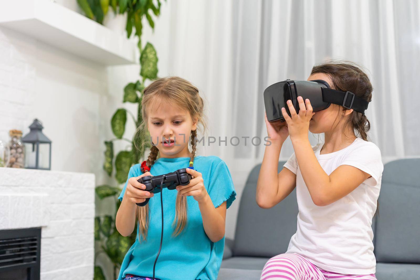 two little girls using glasses of virtual reality headset. concept of modern technologies