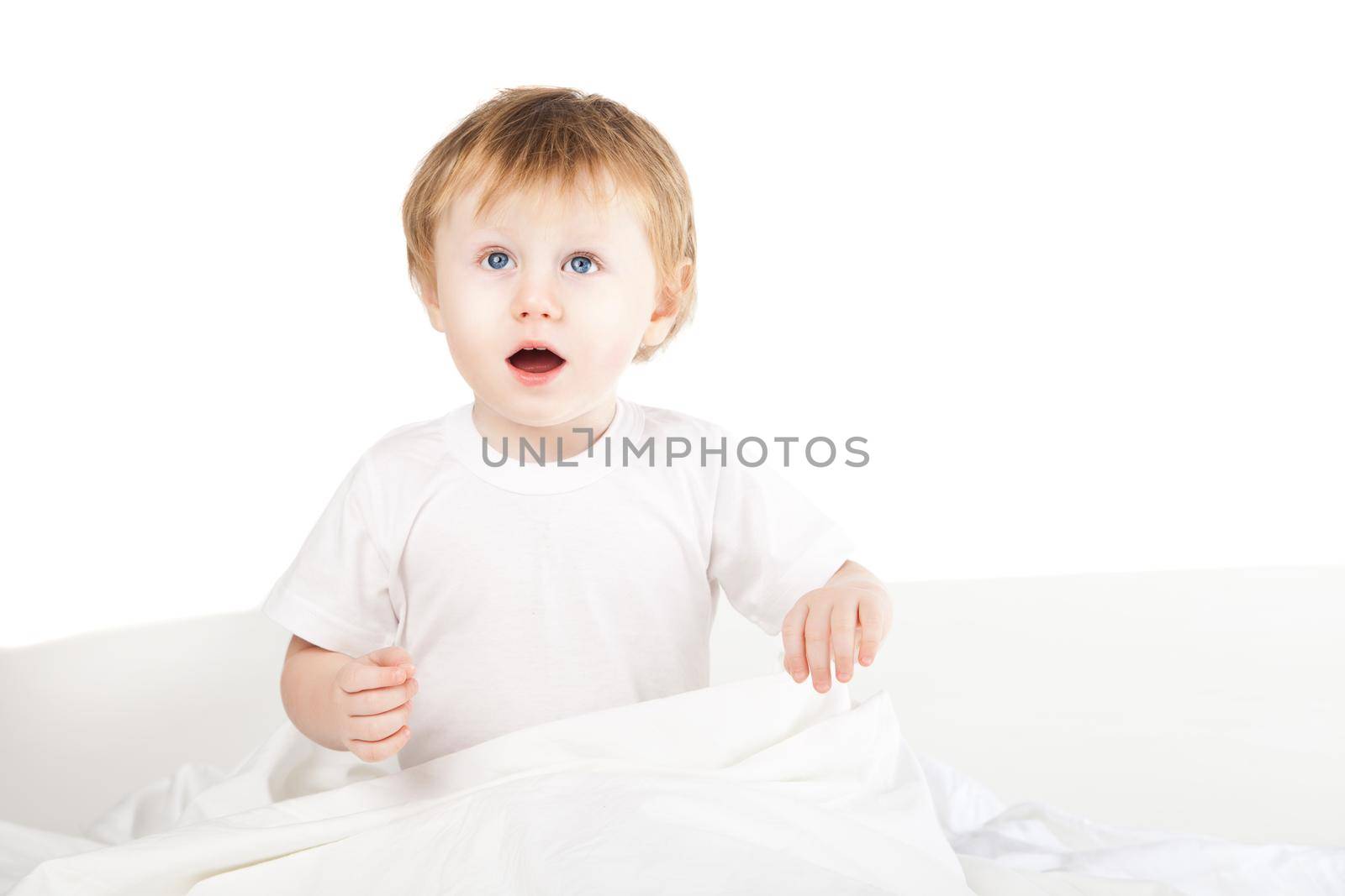 cute excited baby girl in bed at home over white by Julenochek
