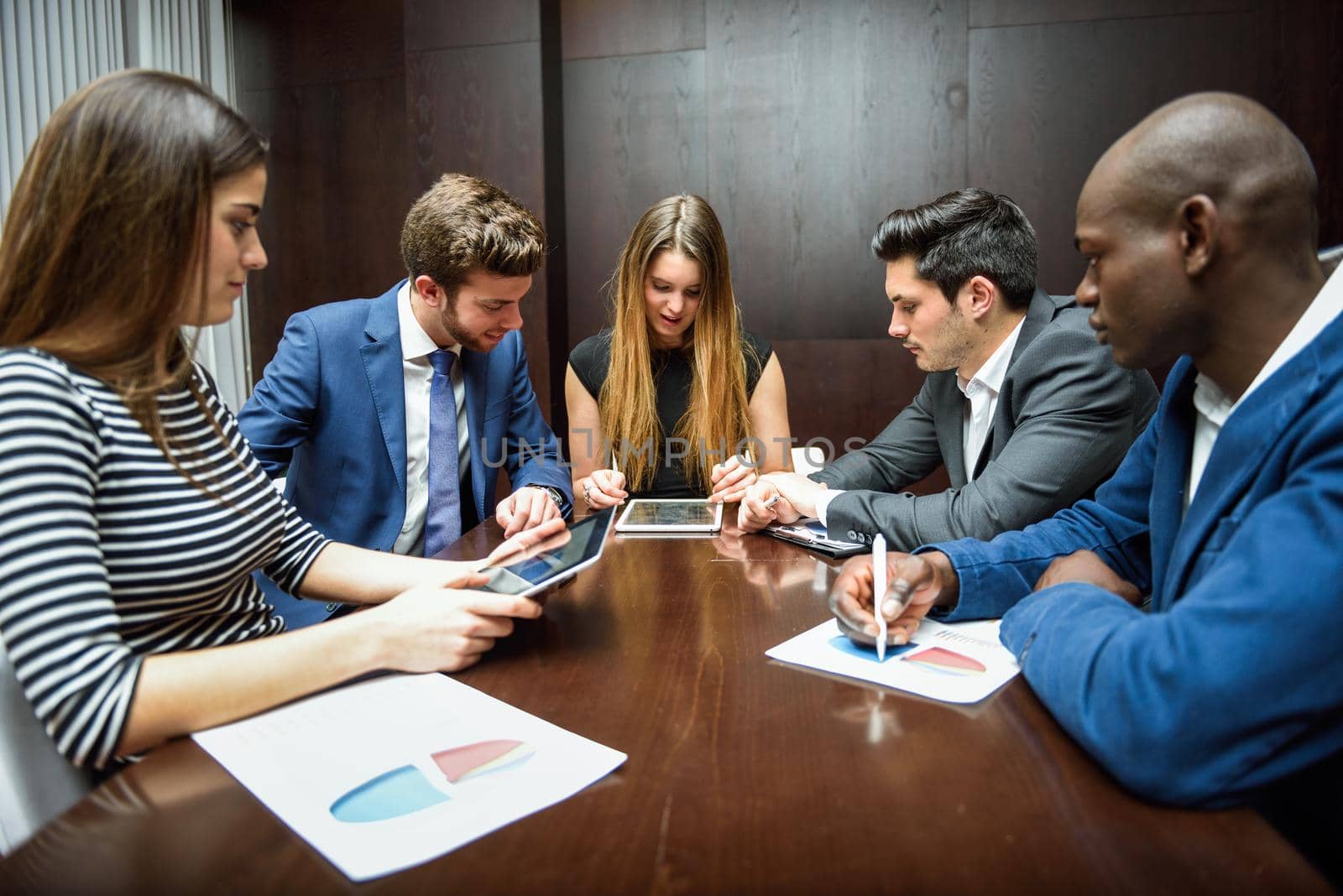 Businesspeople, teamwork. Group of multiethnic busy people working in an office