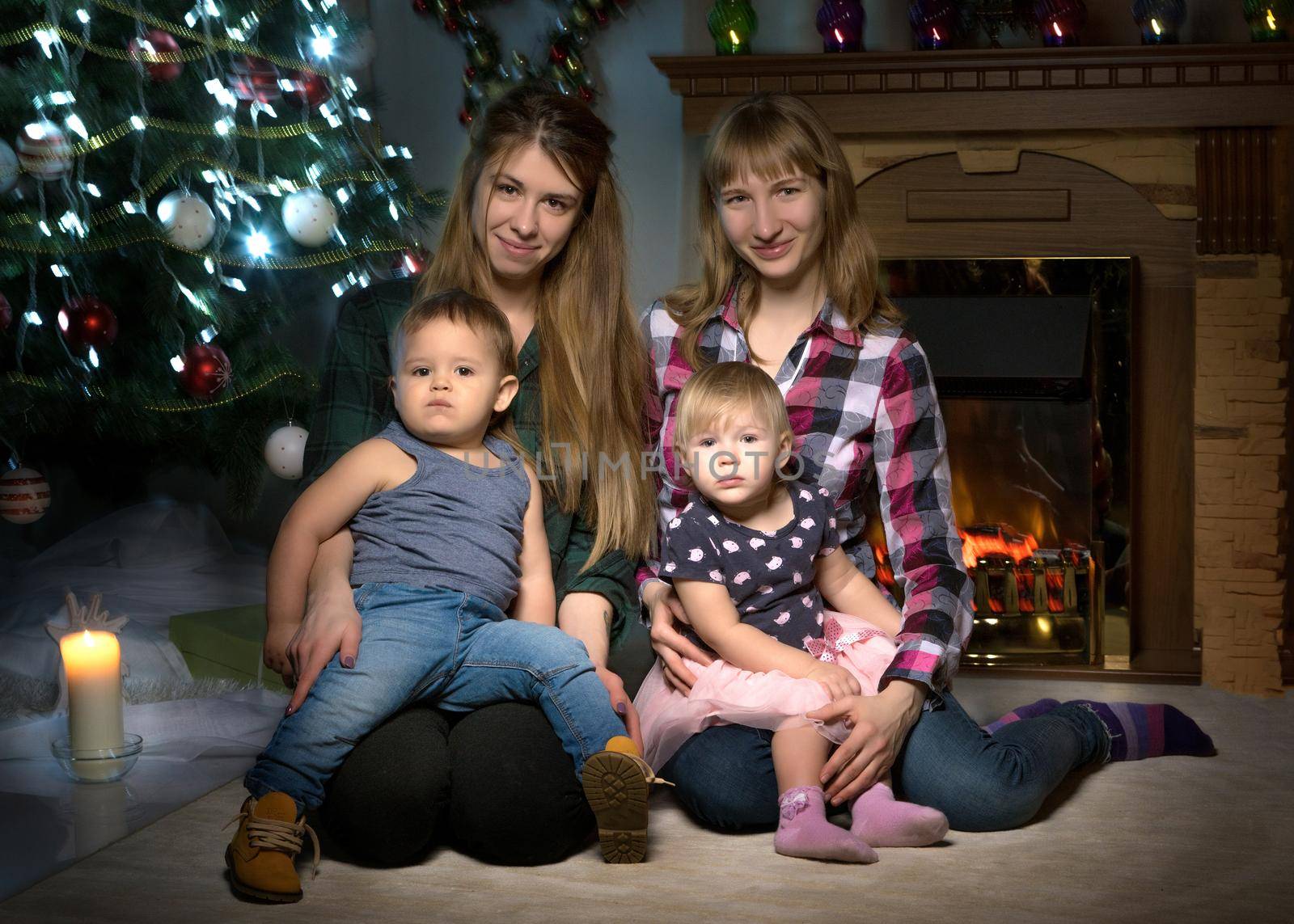 Young mothers with children at the Christmas tree. by kolesnikov_studio