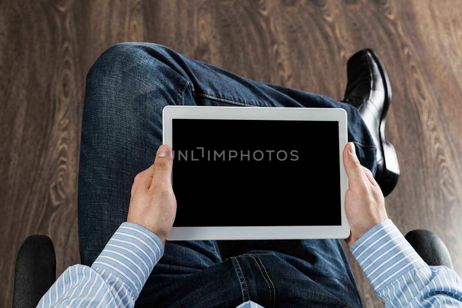 close-up of men's hands with a computer tablet. Businessman works in the office