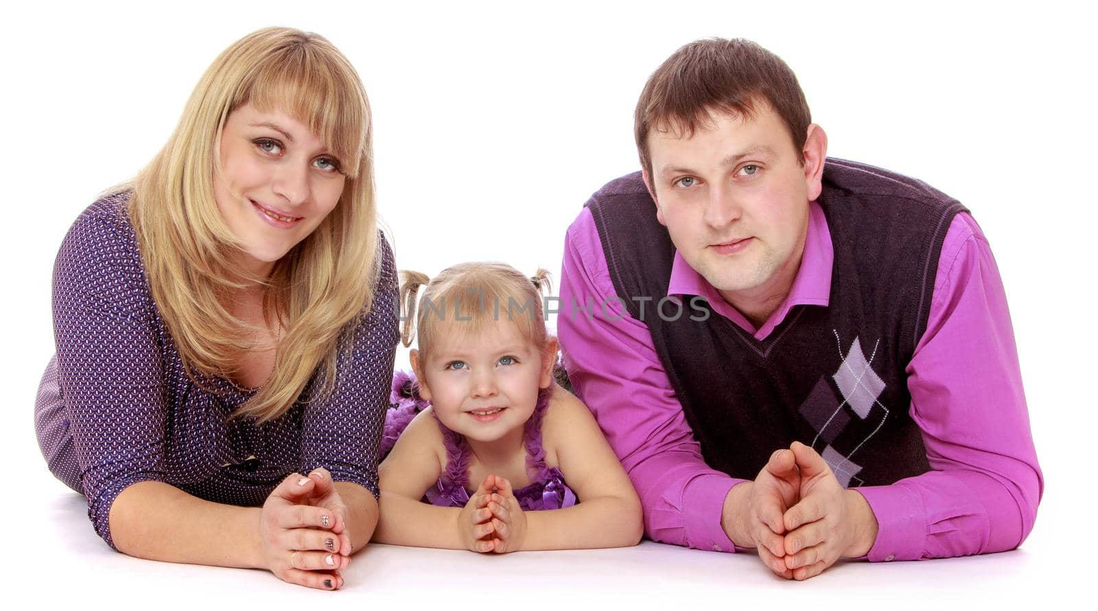 Happy family of three mom, dad and adorable little daughter lie on the floor and looking at camera-Isolated on white background