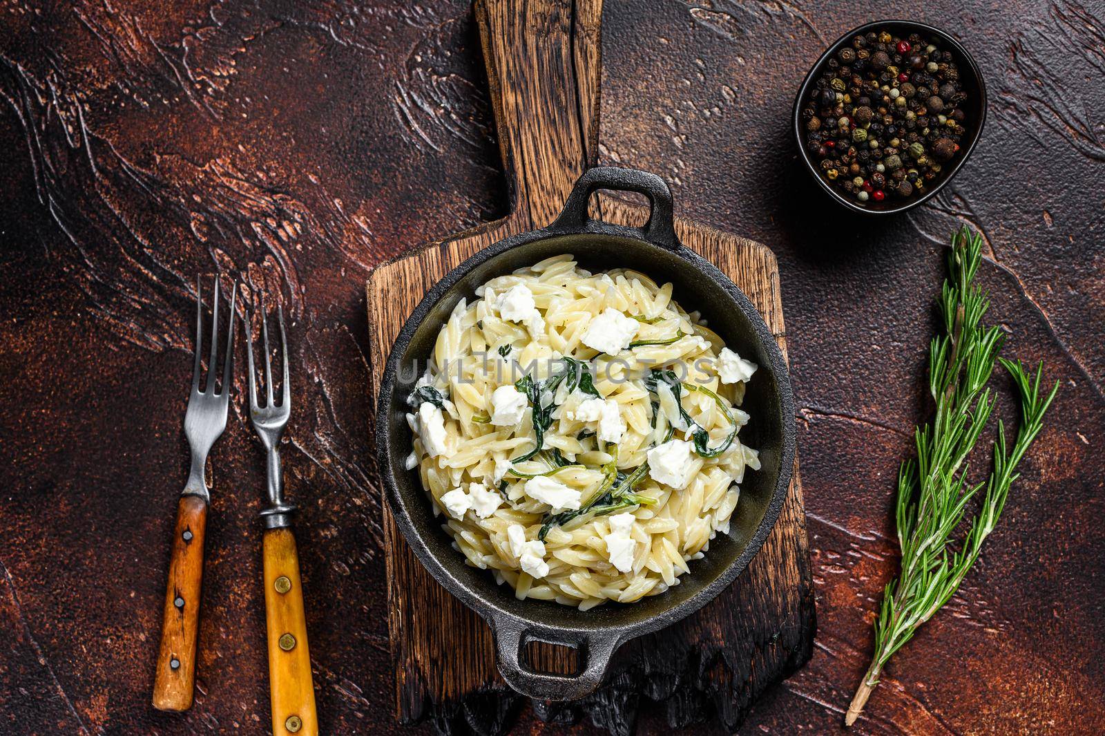 Orzo primavera with green veggies spinach. Dark wooden background. Top view by Composter
