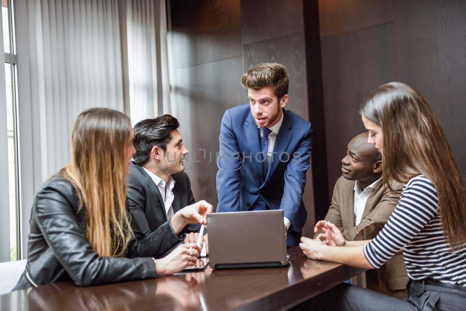 Group of multiethnic busy people working in an office by javiindy