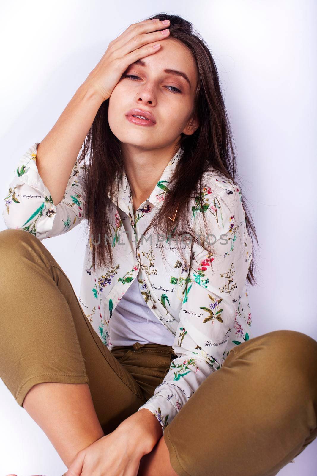 young pretty teenage hipster girl posing emotional happy smiling on white background, lifestyle people concept close up