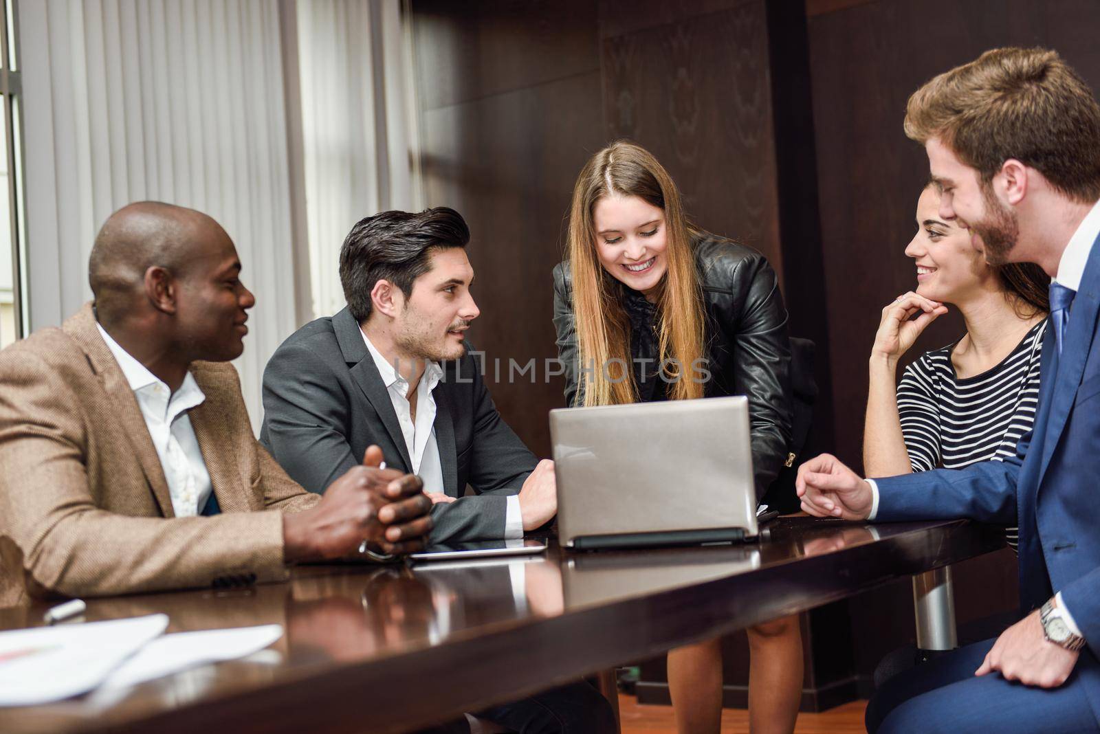 Businesspeople, teamwork. Group of multiethnic busy people working in an office