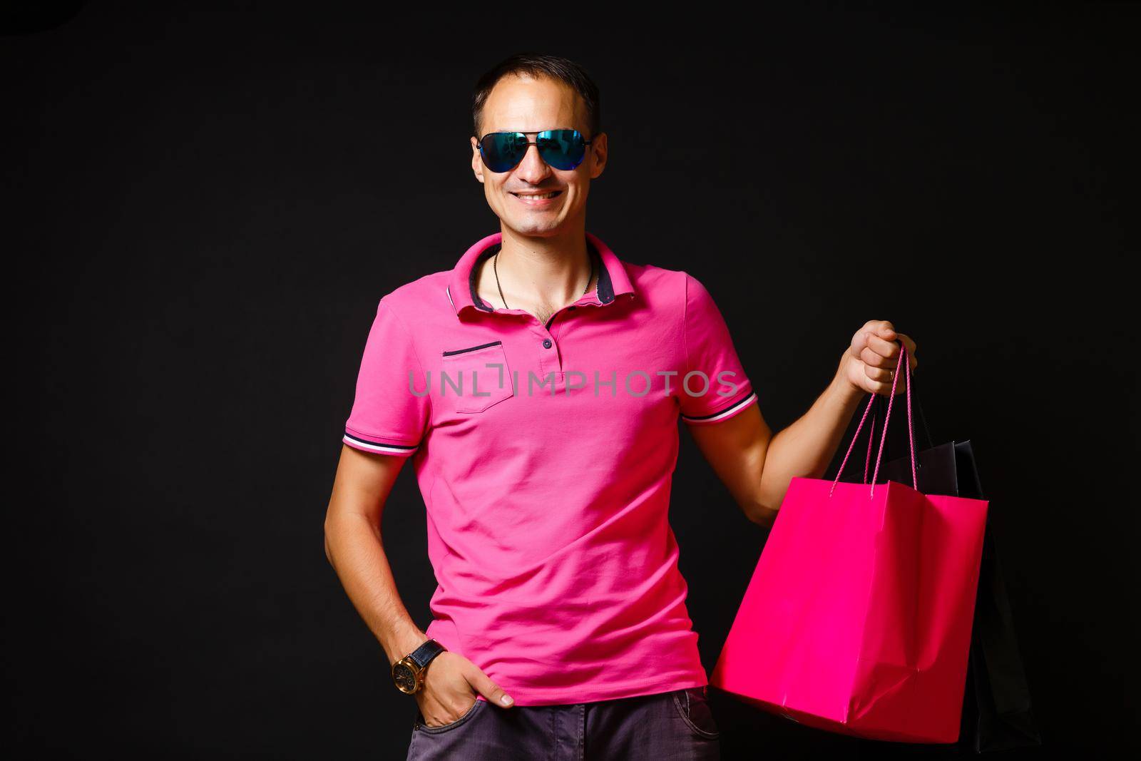 young caucasian man is holding shopping bags