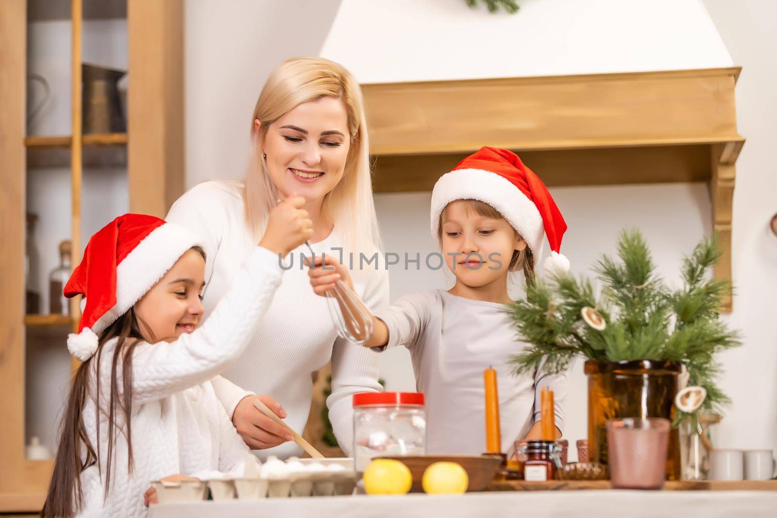 Happy family at christmas. Mother and daughters having fun at home