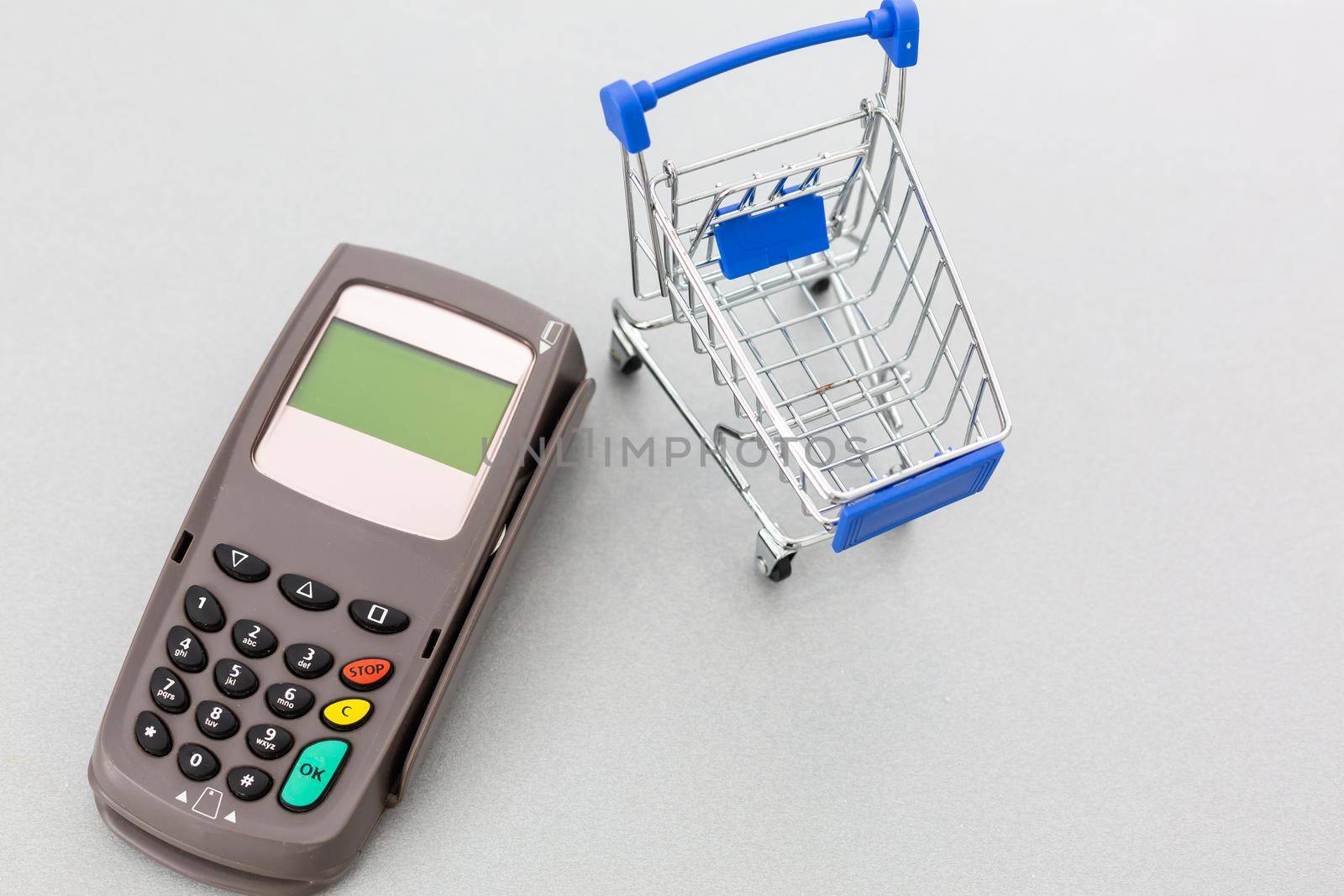 Top view photo of shopping trolley and cash register