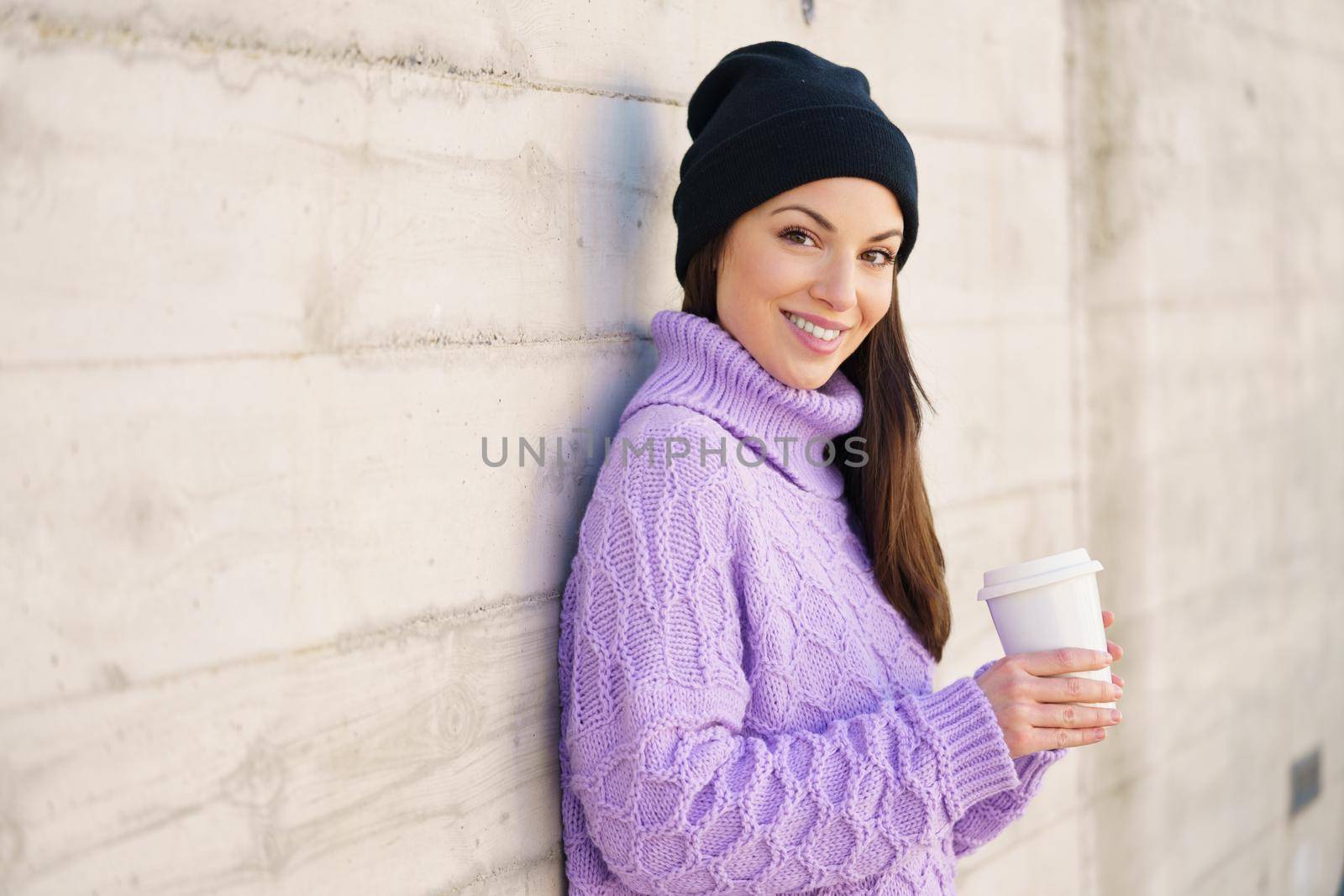 Woman in her twenties taking a coffee break outdoors. Lifestyle concept.