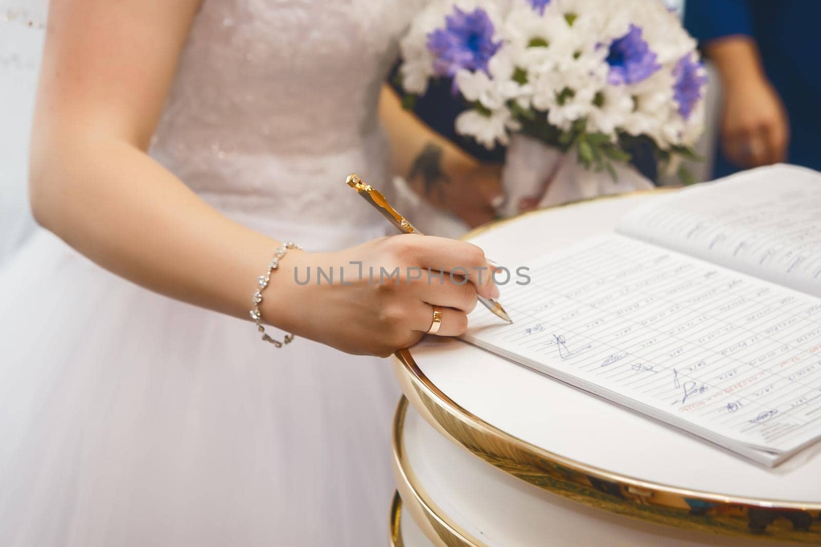 Bride's hands put signature on consent to marriage in registry office by AYDO8