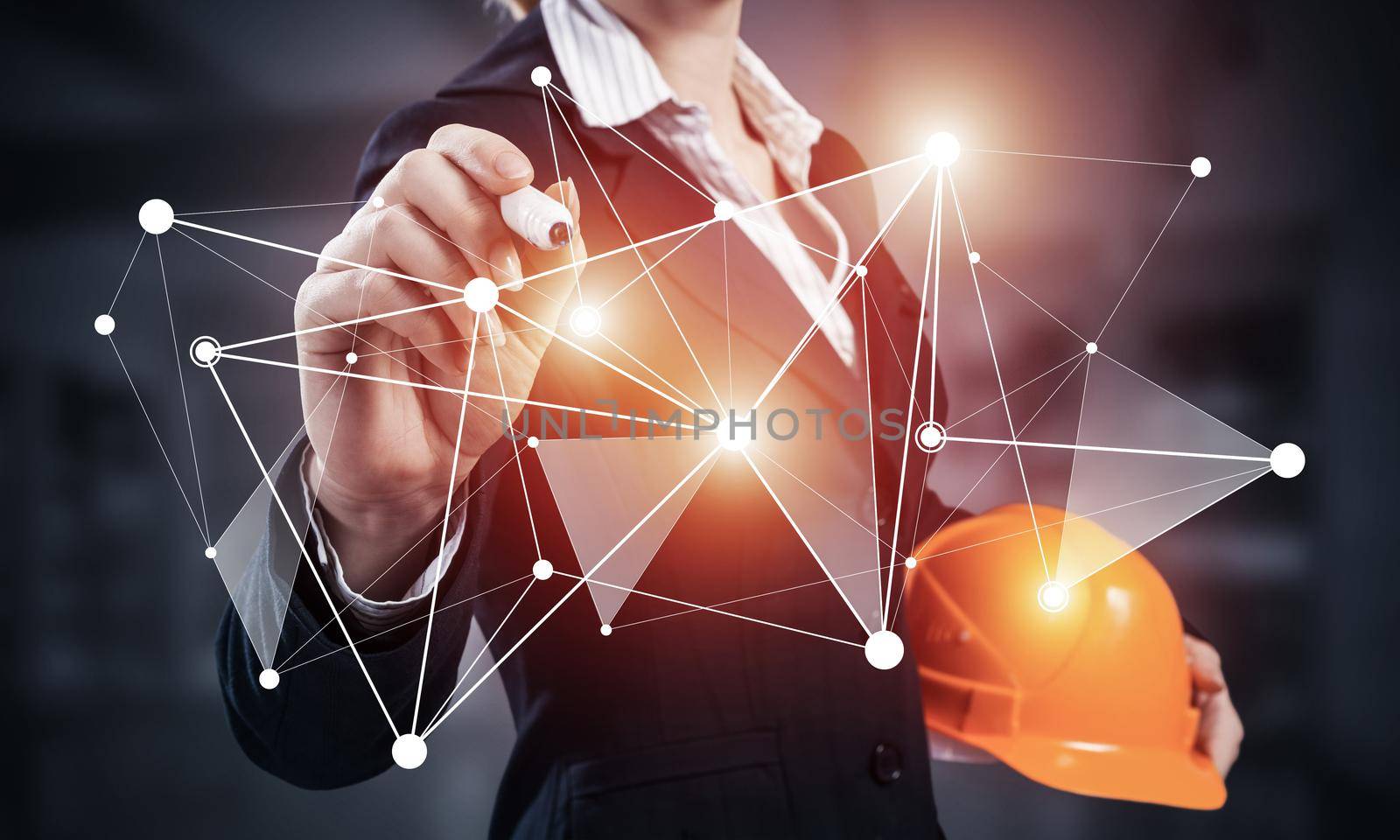 Businesswoman pointing on abstract 3d network. Woman engineer in business suit holding safety helmet. Engineering and project management. Social connection and networking concept with plexus structure
