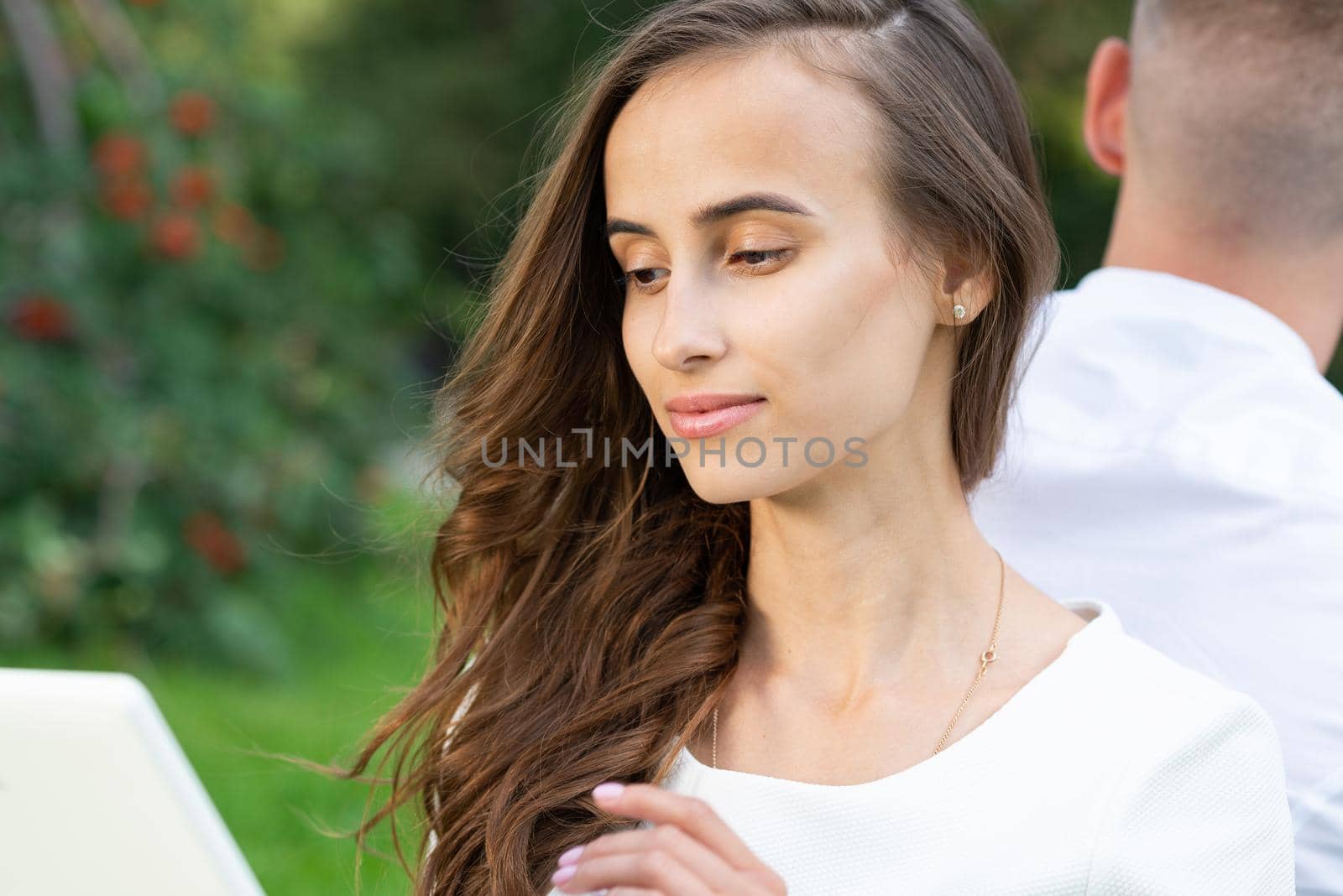 woman with a computer tablet. work in the park